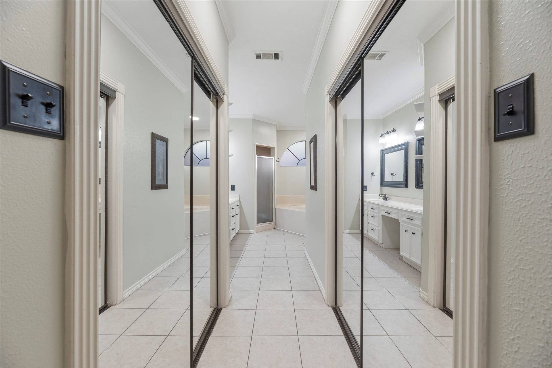 5823 Ashmere Lane, Spring, TX 77379 Two mirrored closets lead to the primary ensuite bath, offering convenient storage and plenty of space to organize your wardrobe.