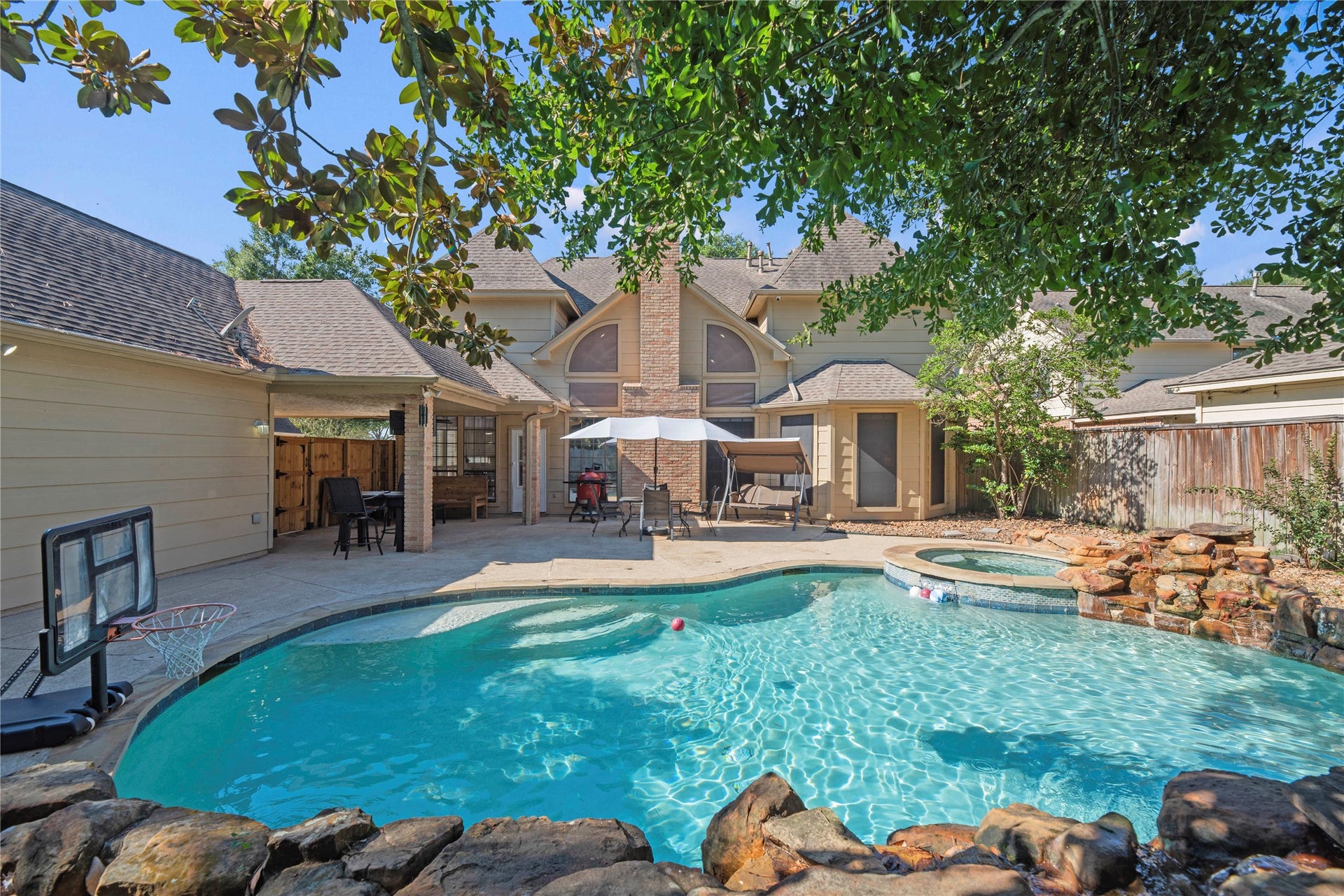 5823 Ashmere Lane, Spring, TX 77379 This backyard has everything you need to make the most of your time at home. Take a dip in the heated pool, relax in the spa or enjoy the soothing sounds of the cascading rock waterfalls. With a spacious covered patio, plenty of deck space and a cozy fire pit area, there's room for everything from peaceful afternoons to weekend pool parties that everyone will look forward to!