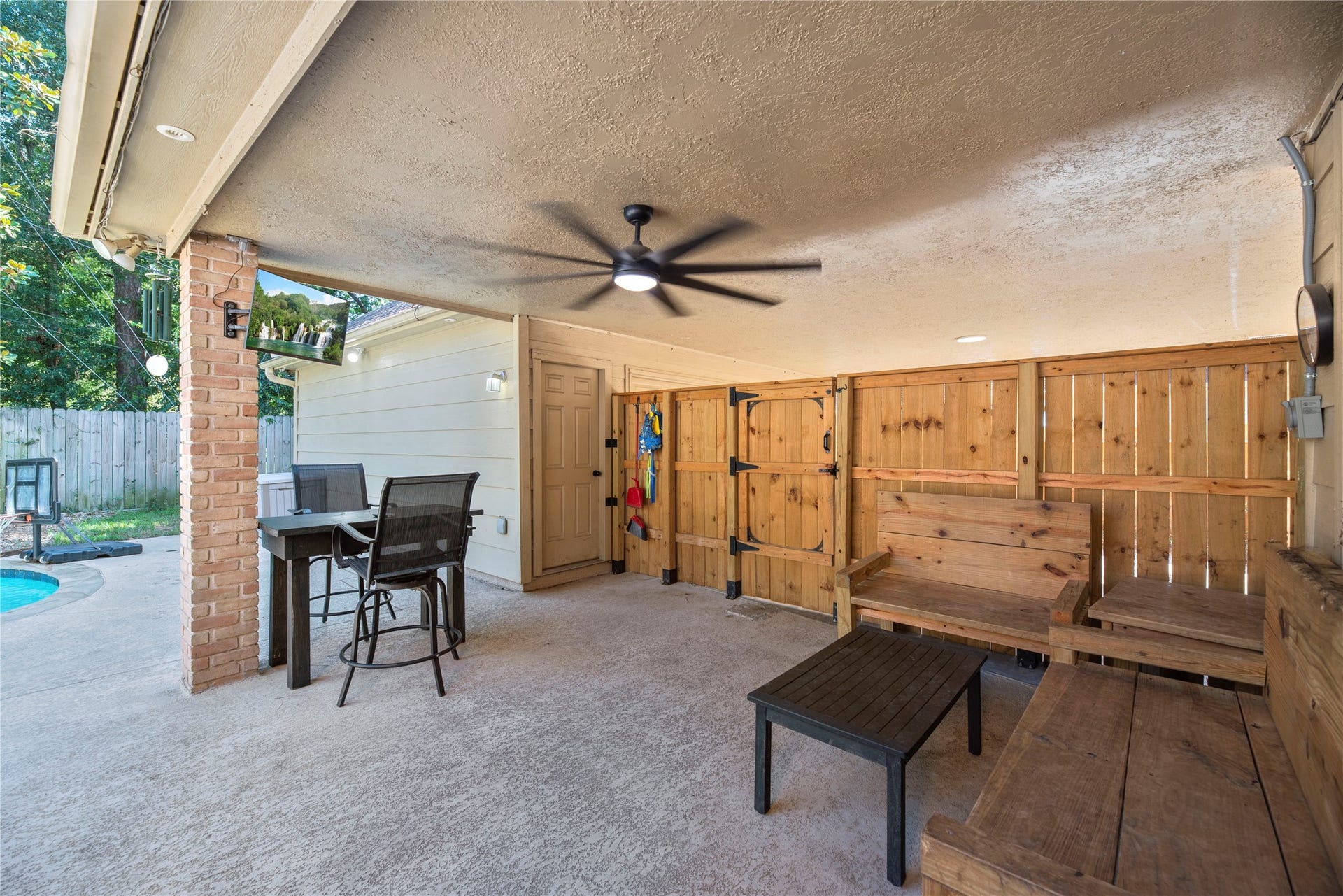 5823 Ashmere Lane, Spring, TX 77379 There's plenty of room to relax and enjoy the outdoors on this spacious covered patio. With a ceiling fan, outdoor TV and easy access to the pool, it's a great place to escape the sun, catch the game or spend a laid-back afternoon poolside with family and friends.