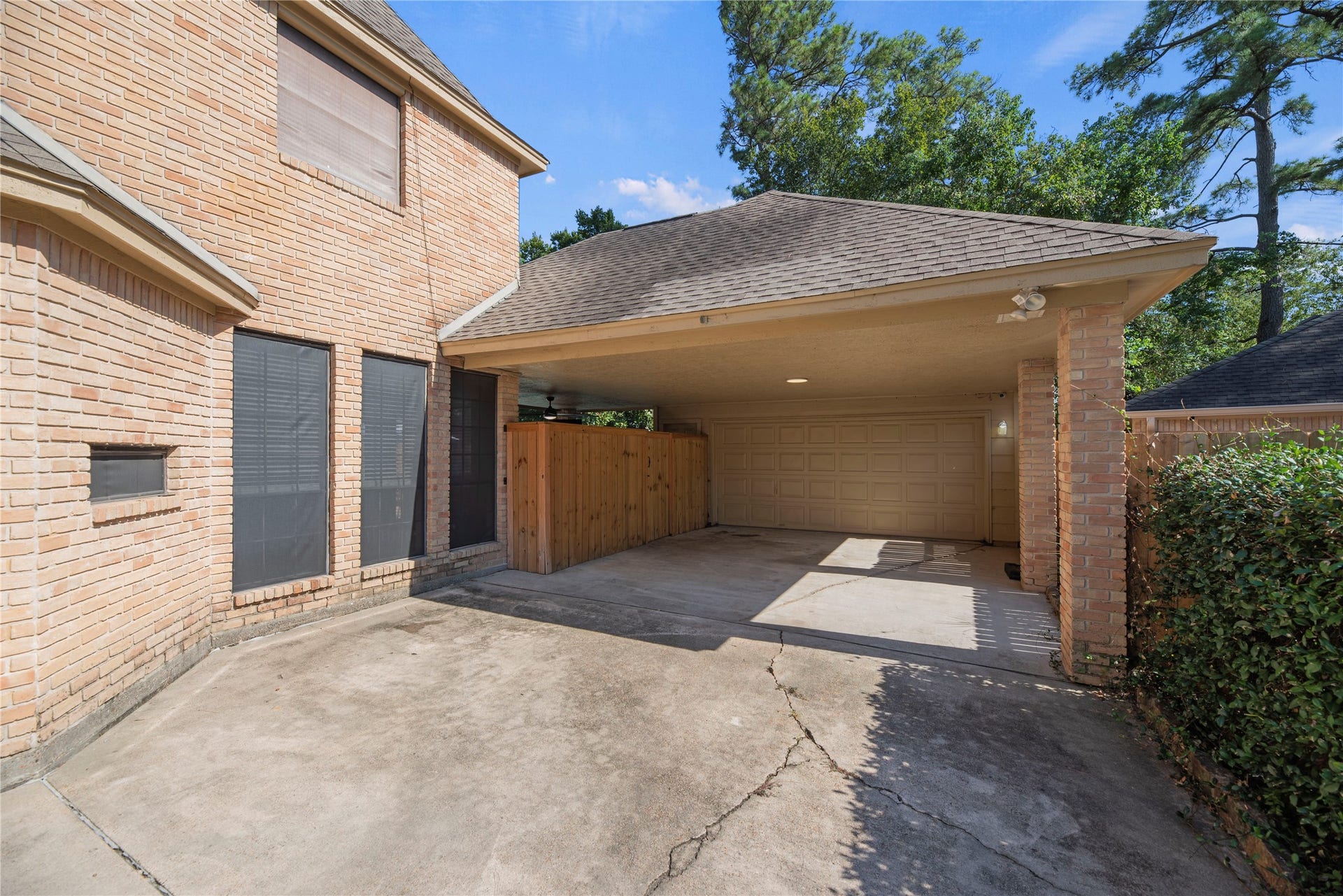 5823 Ashmere Lane, Spring, TX 77379 There's no shortage of parking space here. The extended driveway leads to a spacious covered parking area and detached garage. Inside the garage, a workbench, built-in storage, and decked attic storage are perfect for your next project.