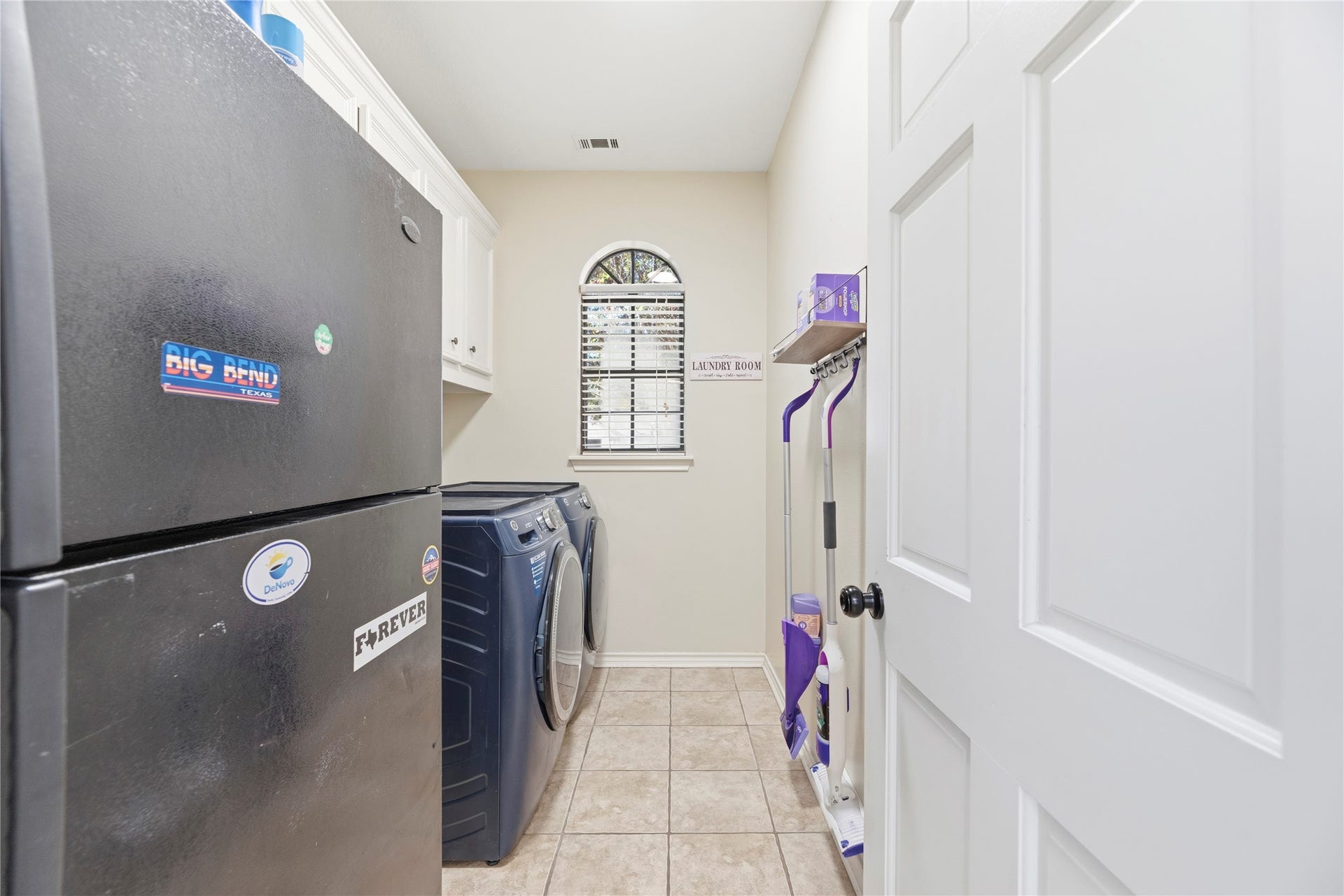 5823 Ashmere Lane, Spring, TX 77379 This convenient utility room offers built-in storage, easy-care tile flooring and plenty of space for your washer, dryer and an extra refrigerator or freezer.