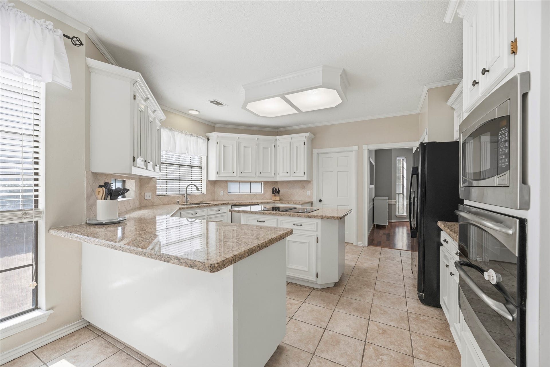 5823 Ashmere Lane, Spring, TX 77379 Whether you're baking holiday treats, preparing Sunday dinner or hosting a houseful of friends, the sleek stainless steel appliances, including double electric ovens, make cooking and entertaining a little easier. Beautiful granite countertops, crisp white cabinetry, a center island with an electric cooktop and a separate breakfast bar provide plenty of space to prep, serve and gather with family and friends.
