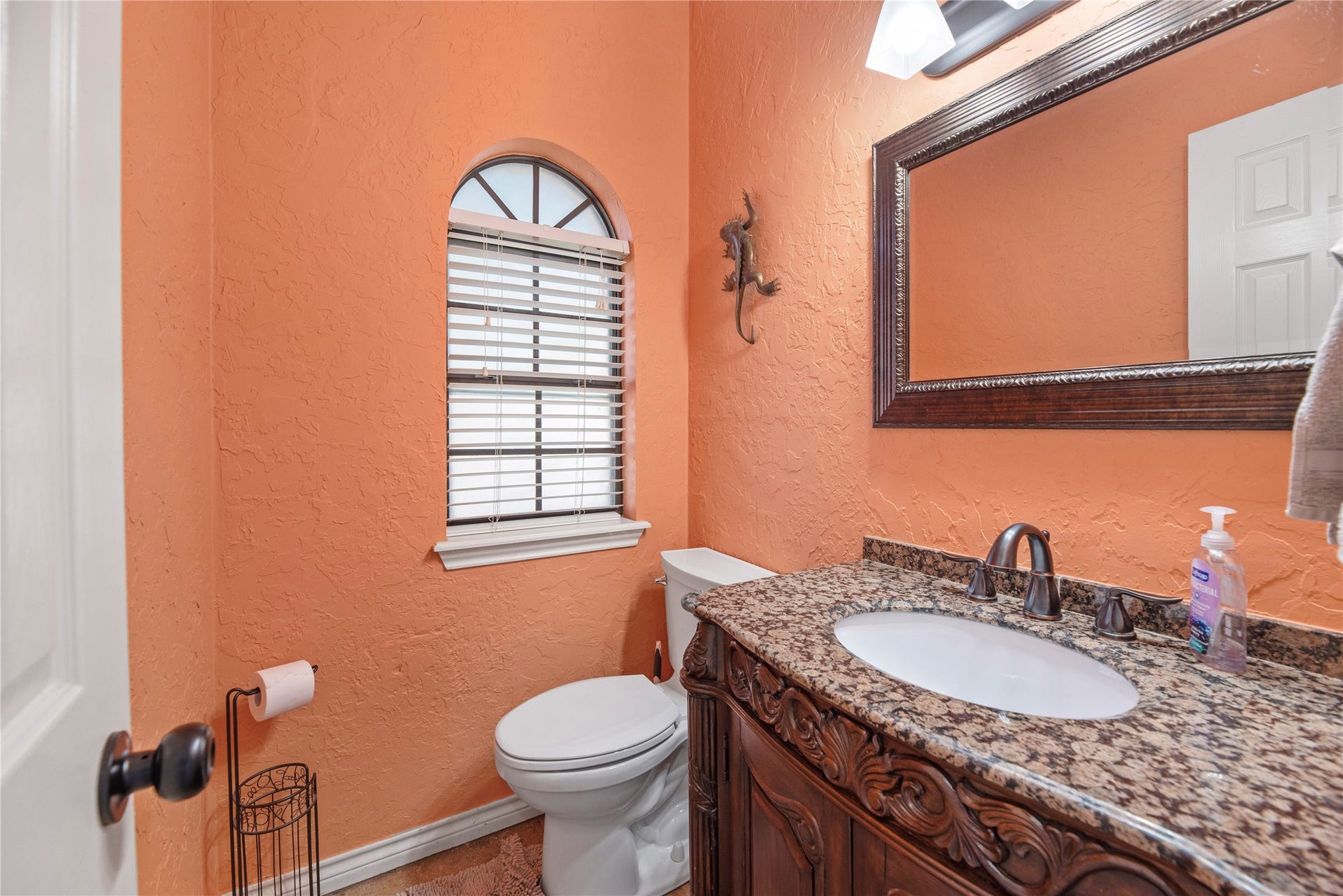 5823 Ashmere Lane, Spring, TX 77379 Full of rustic charm, this inviting powder bath features warm designer paint, a furniture-style vanity with granite countertop, decorative framed mirror and stylish vanity lighting. Convenient for everyday use and welcoming for guests.
