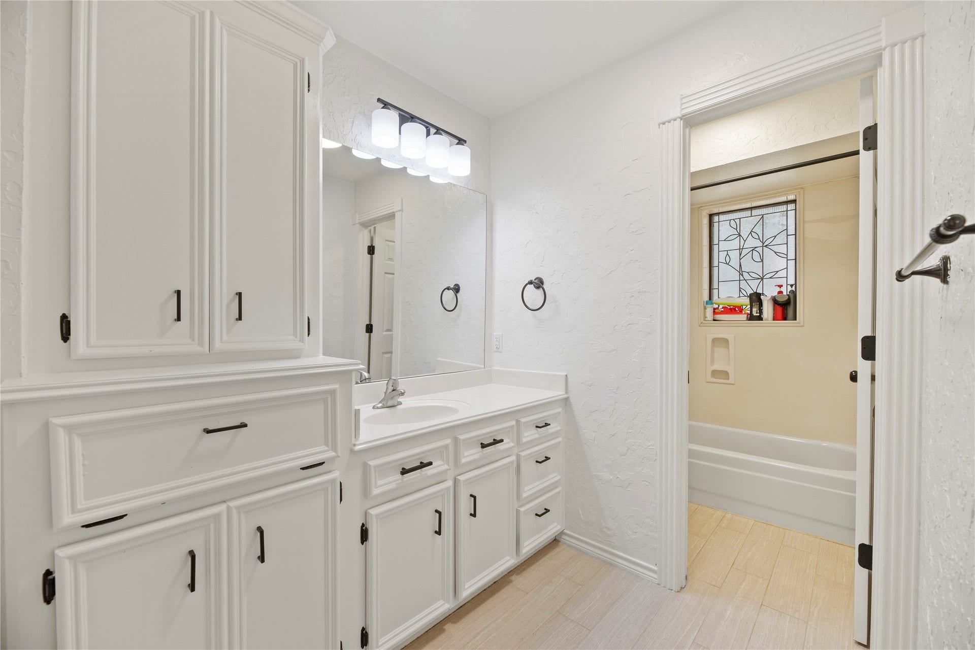5823 Ashmere Lane, Spring, TX 77379 Storage is a standout in this spotless guest bathroom. A built-in storage tower, extended vanity with plenty of cabinets and drawers, and ample counter space make it easy to keep everything organized. The separate water closet with tub/shower and toilet adds privacy and convenience.