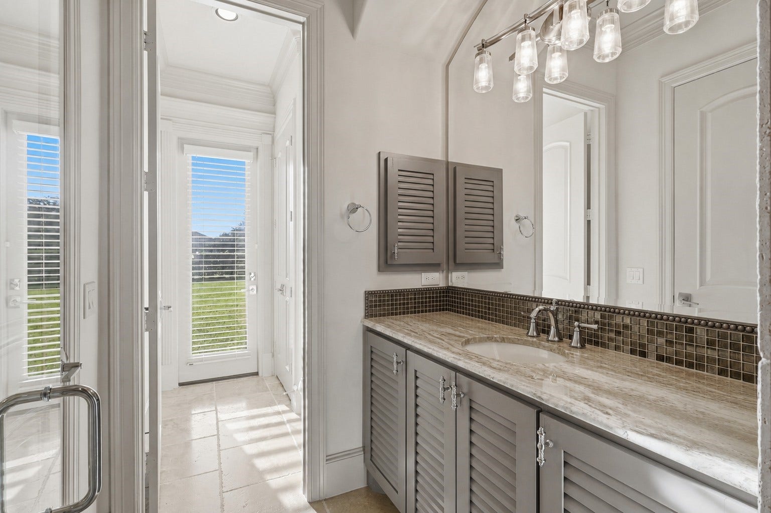 Bedroom 2 ensuite bath with convenient glass-door exterior access.
