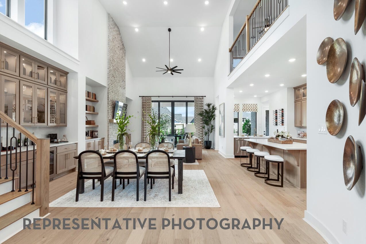 7819 Elizabeth Creek Court, Richmond, TX 77469 Open dining area seamlessly connected to the kitchen and family room beneath soaring ceilings.