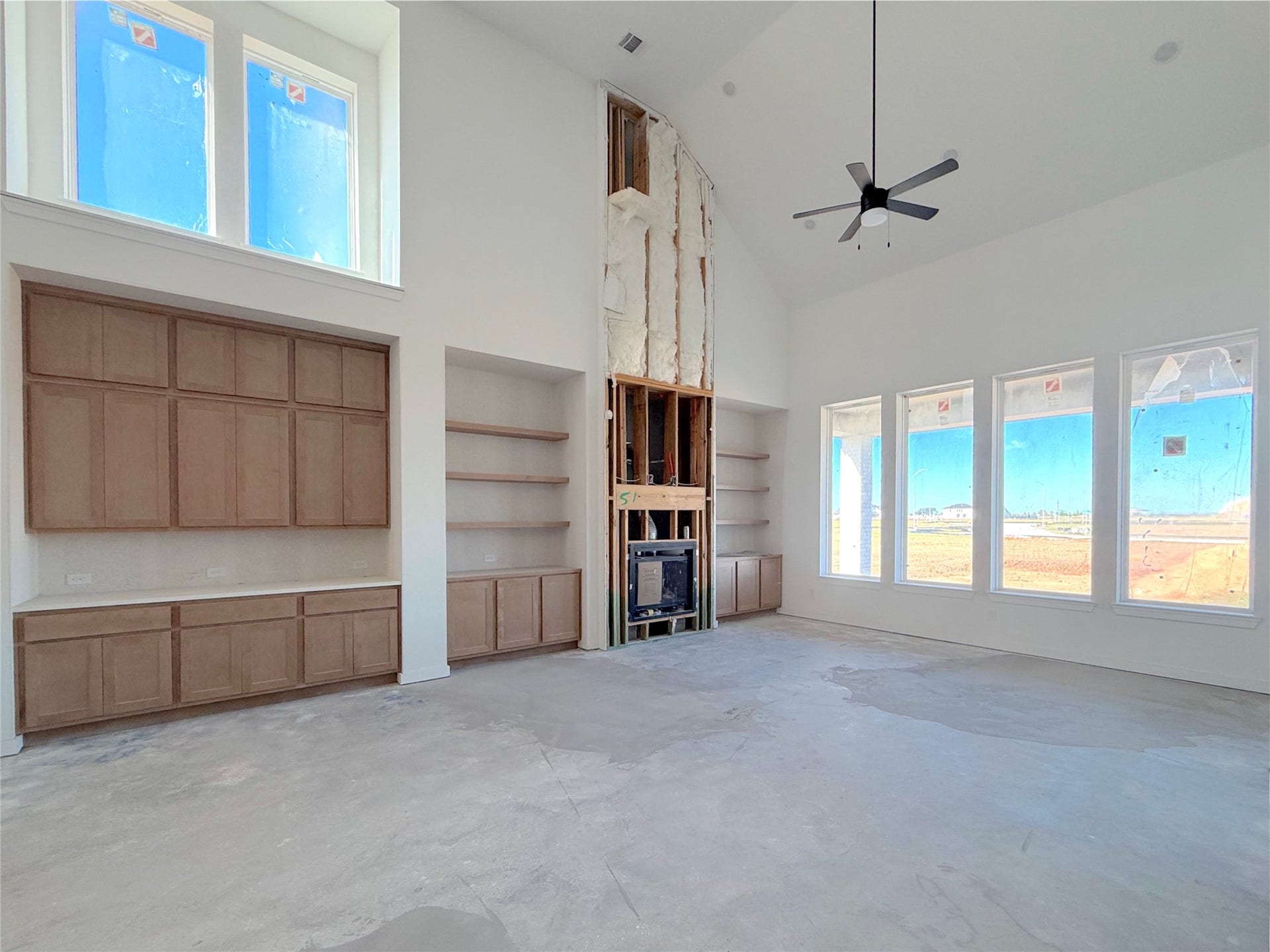 7819 Elizabeth Creek Court, Richmond, TX 77469 Light filled family room showcasing a fireplace with built in surround and open views of the main living spaces