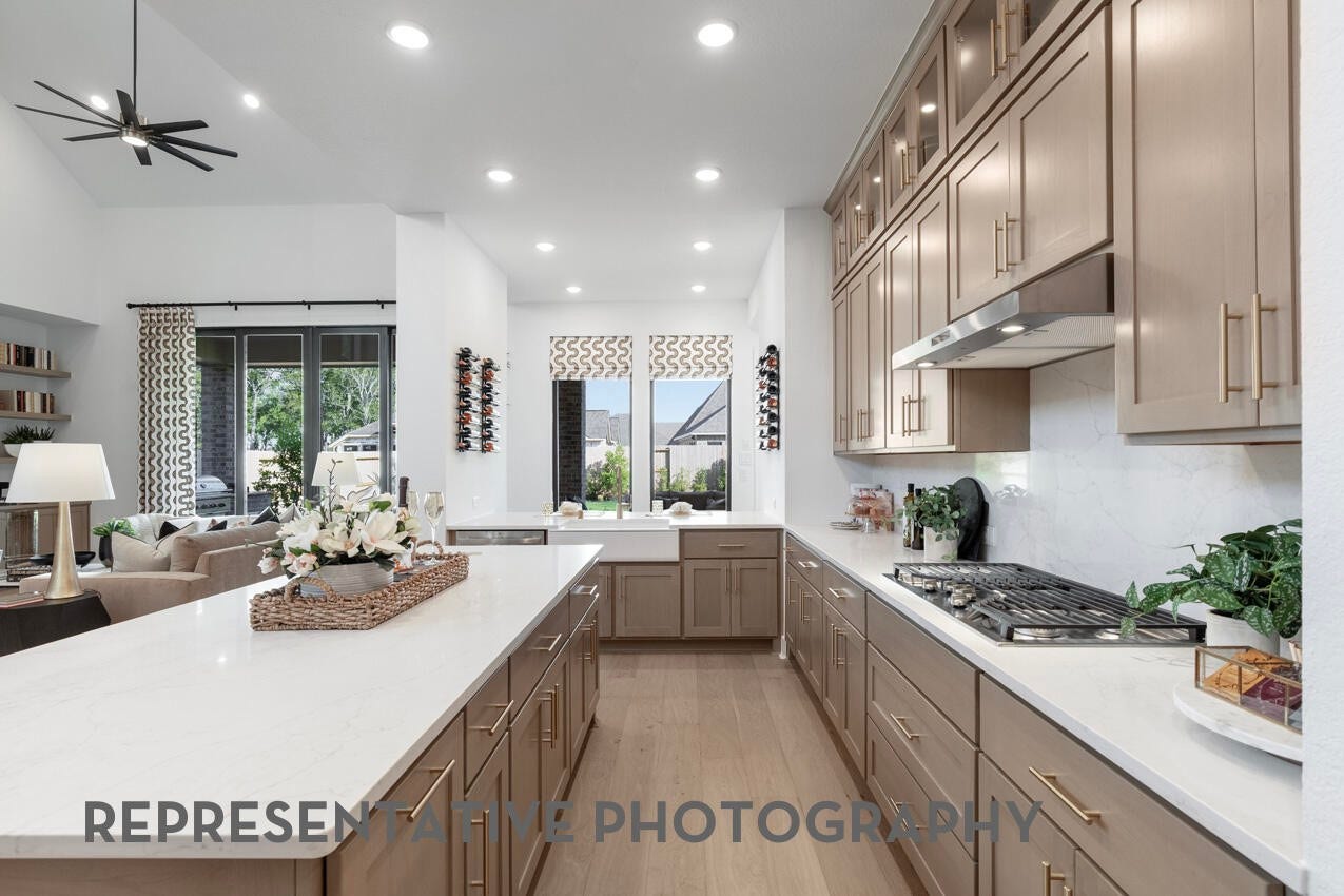 7819 Elizabeth Creek Court, Richmond, TX 77469 Chef-inspired kitchen with a gas cooktop, built-in appliances, and a large island perfect for entertaining.