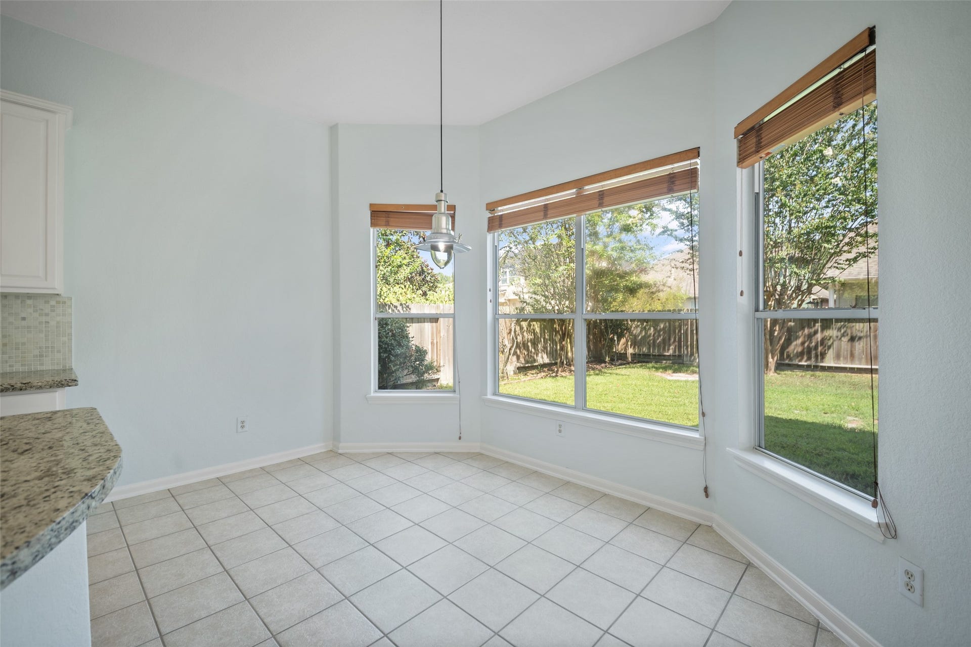 breakfast nook gleaming with natural light and great view of backyard