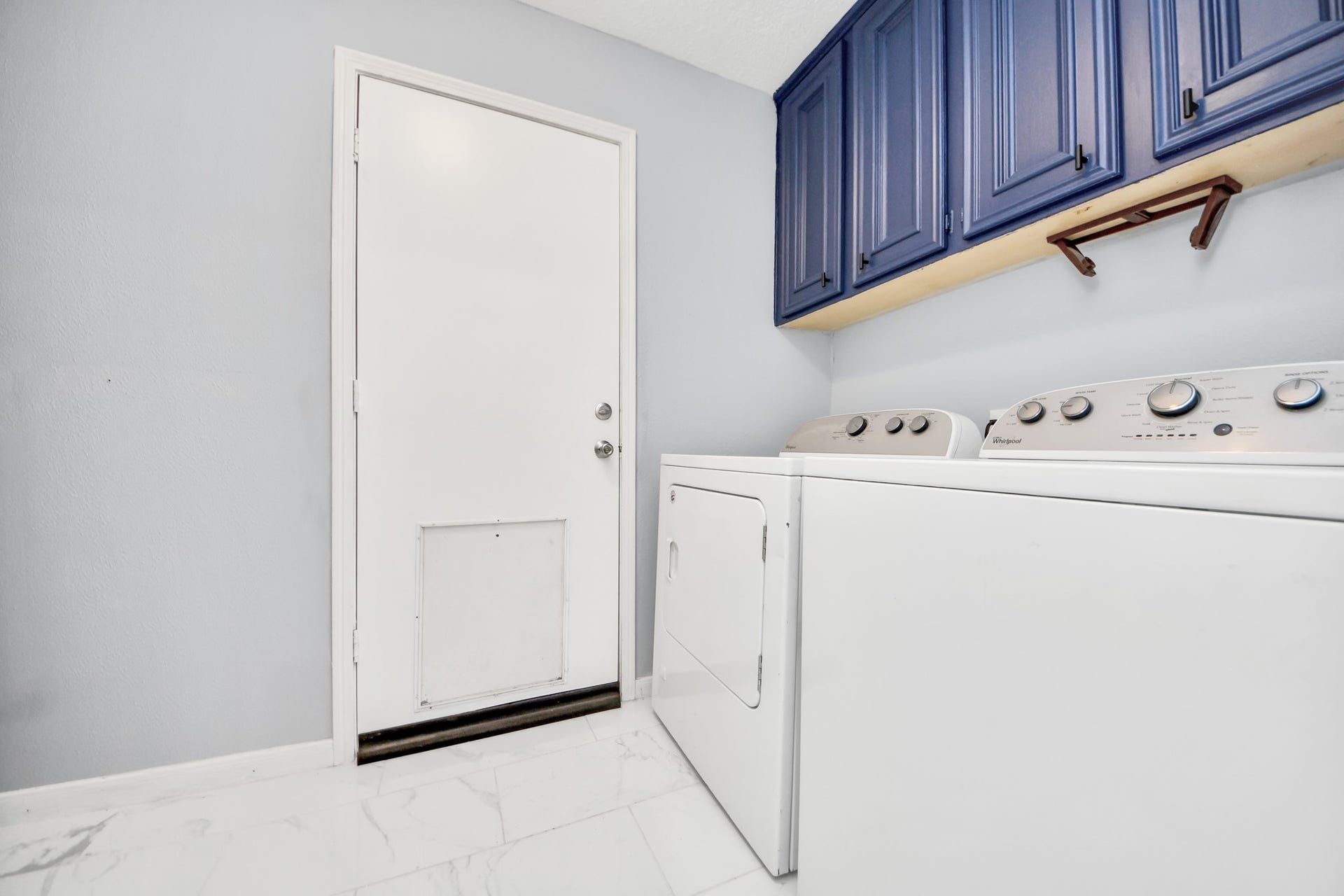 2903 Blue Glen Lane, Houston, TX 77073 This high-utility space keeps chore day organized with a vibrant row of cool blue overhead cabinetry positioned perfectly above the washer and dryer hookups.