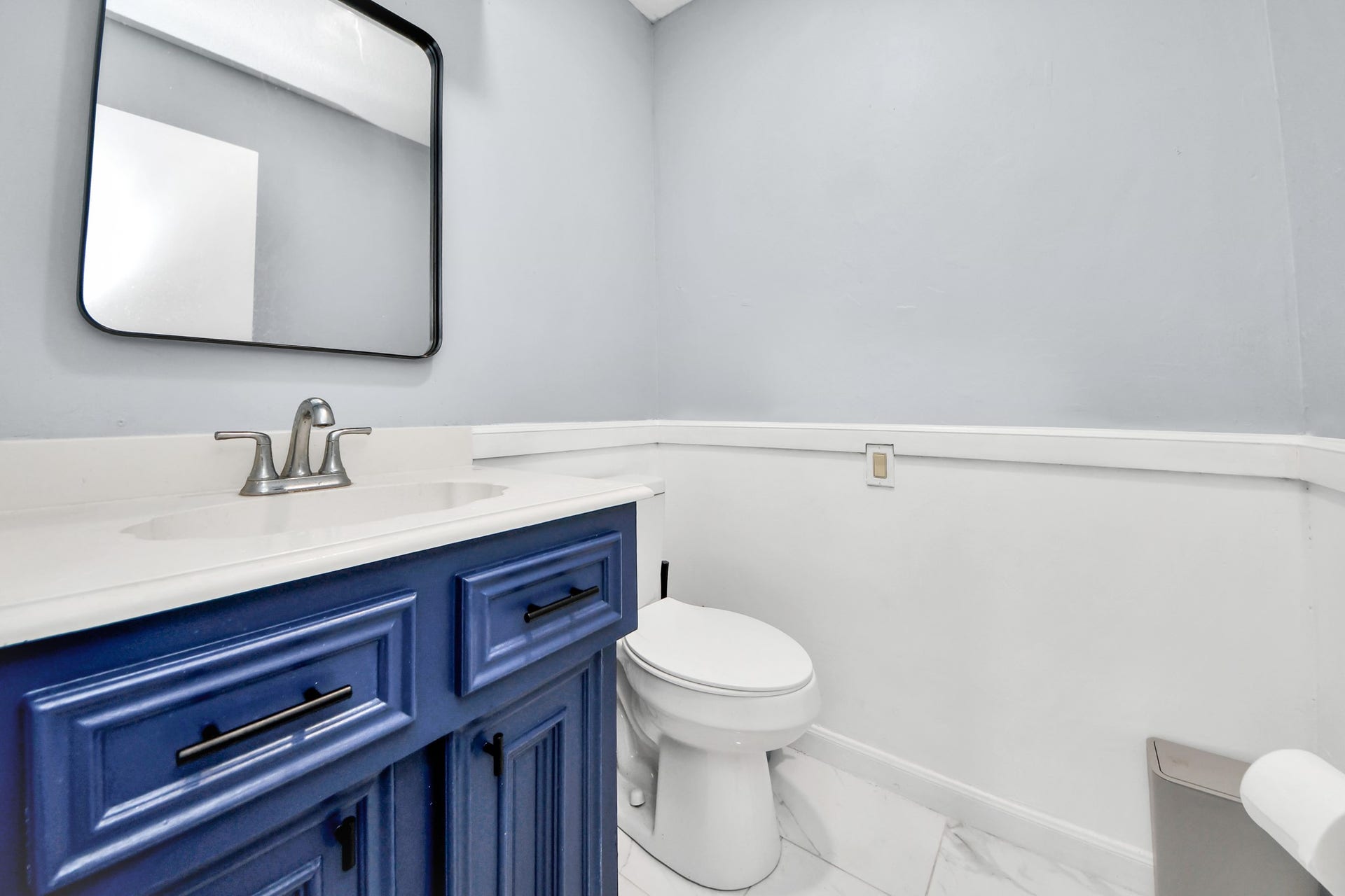 2903 Blue Glen Lane, Houston, TX 77073 A brilliant splash of designer personality. A striking blue vanity pops beautifully against a pristine, light background, offering a memorable and upscale presentation for visiting guests.
