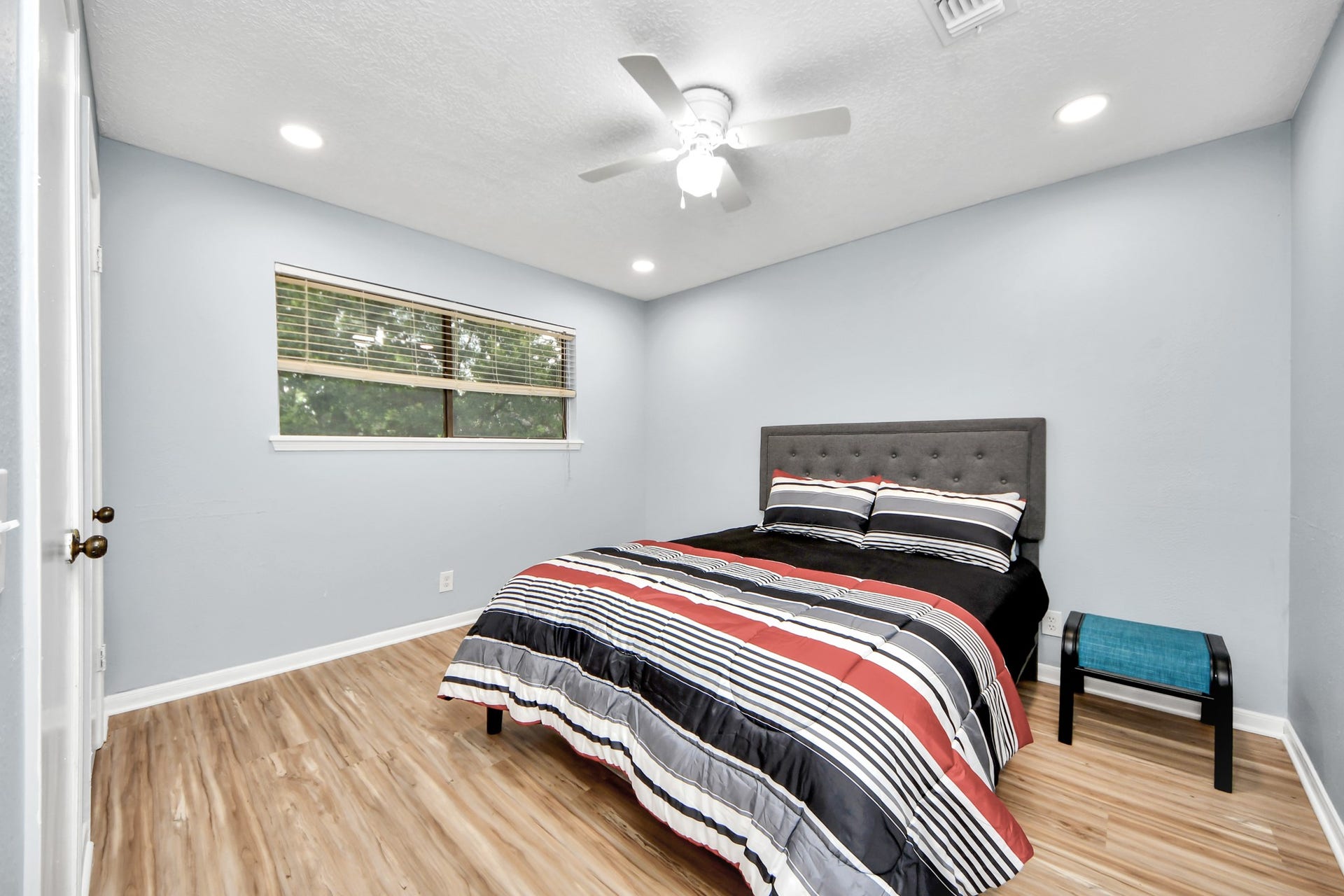 2903 Blue Glen Lane, Houston, TX 77073 Modern recessed lighting and a ceiling fan elevate this secondary bedroom, which benefits from a wide window.