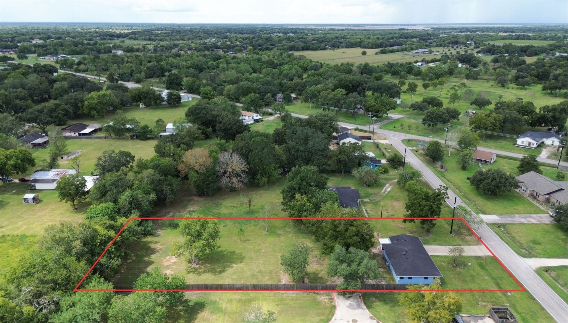 2605 W Dumble Street, Alvin, TX 77511 Experience tranquil rural living on this spacious lot, beautifully enveloped by lush greenery and mature trees, offering unmatched privacy and endless development possibilities.