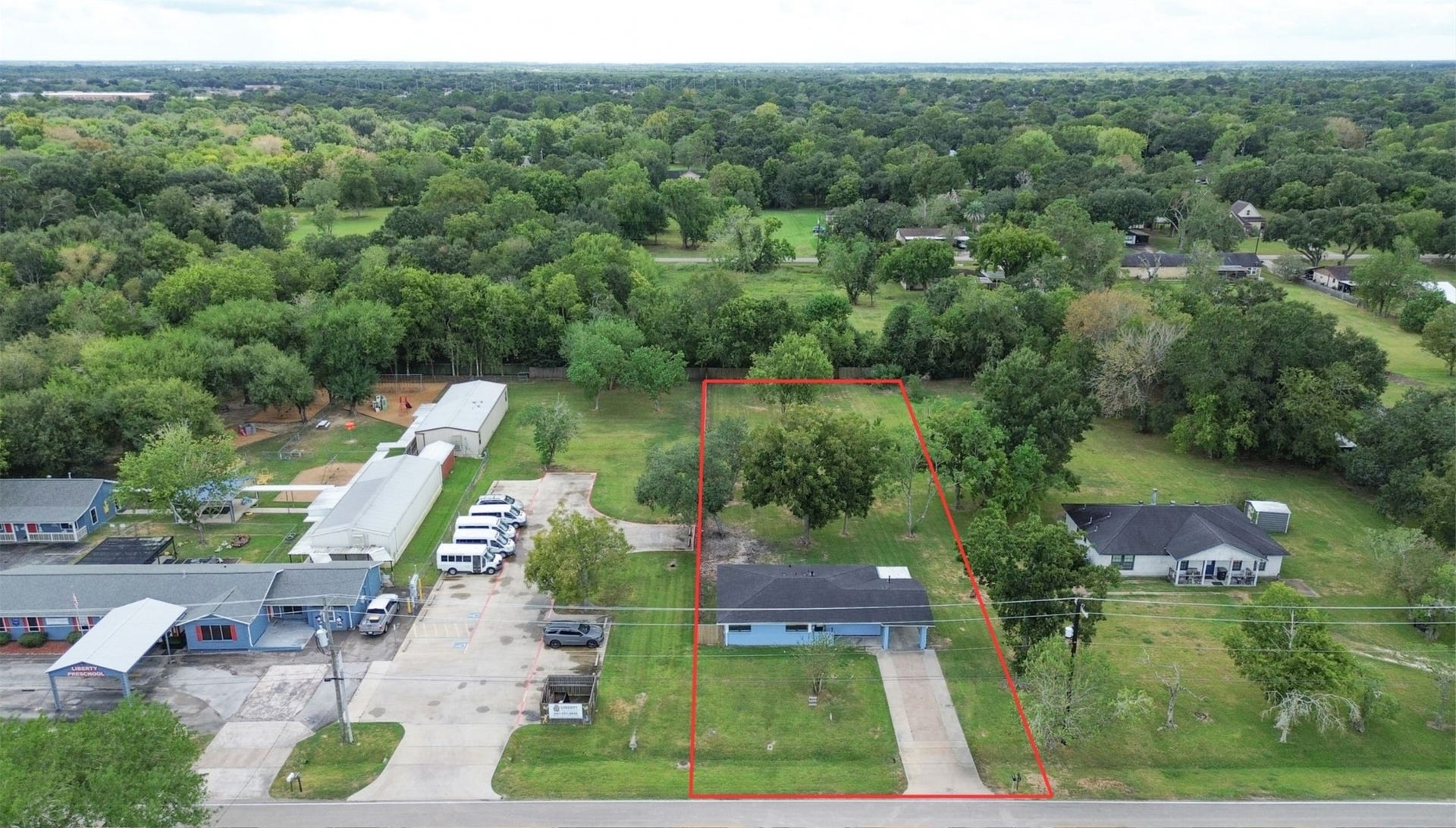 2605 W Dumble Street, Alvin, TX 77511 Charming single-story home nestled on a spacious, lush lot with mature trees, offering ultimate privacy and a serene atmosphere.