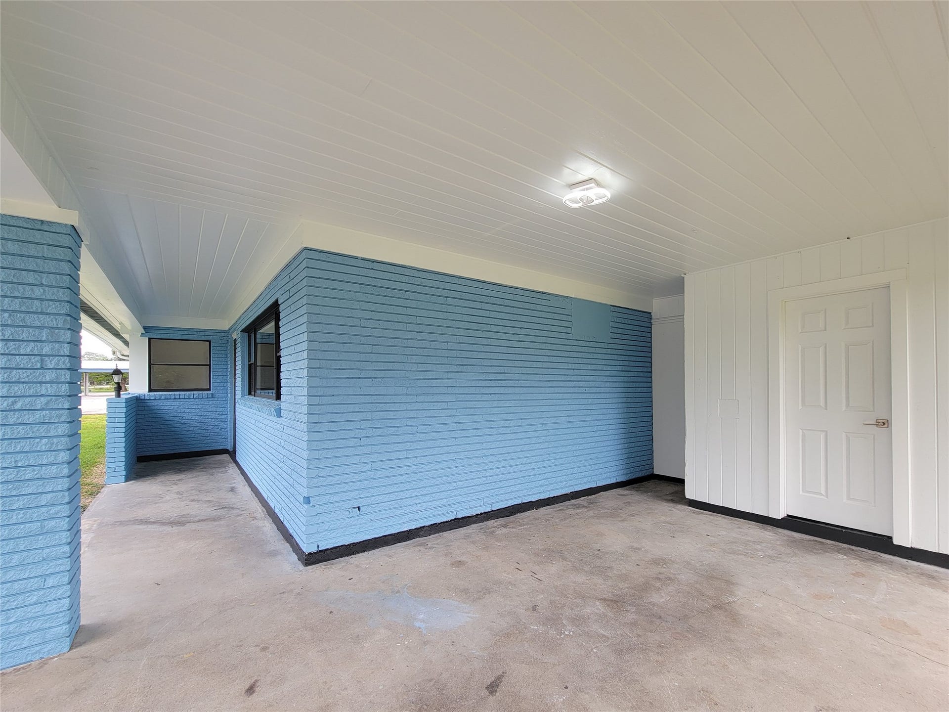 2605 W Dumble Street, Alvin, TX 77511 Experience outdoor relaxation and entertainment in this charming covered patio, featuring cozy blue brick accents.