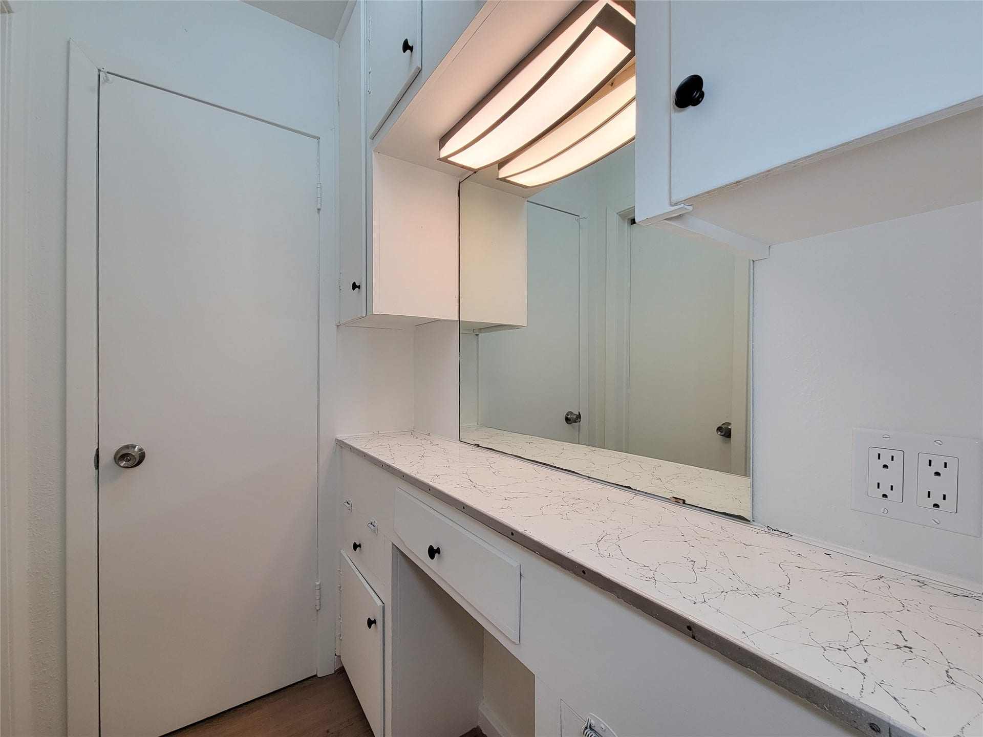 2605 W Dumble Street, Alvin, TX 77511 Experience a bright and functional vanity area with sleek countertops, modern lighting, and ample storage for all your needs.
