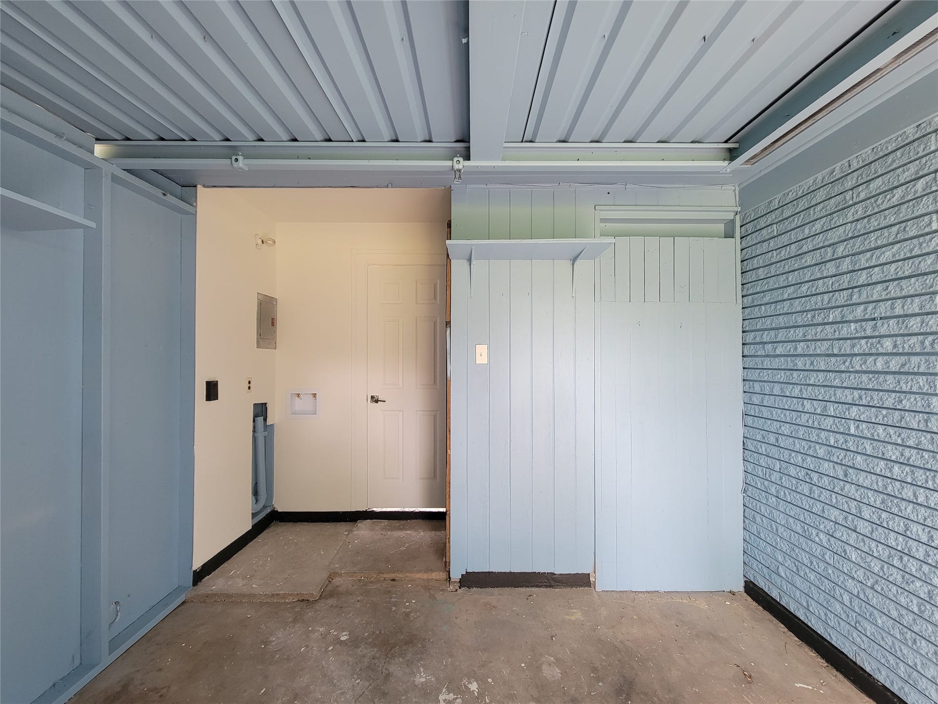 2605 W Dumble Street, Alvin, TX 77511 Expansive garage featuring durable flooring, abundant storage options, and seamless access to the main home for ultimate convenience.