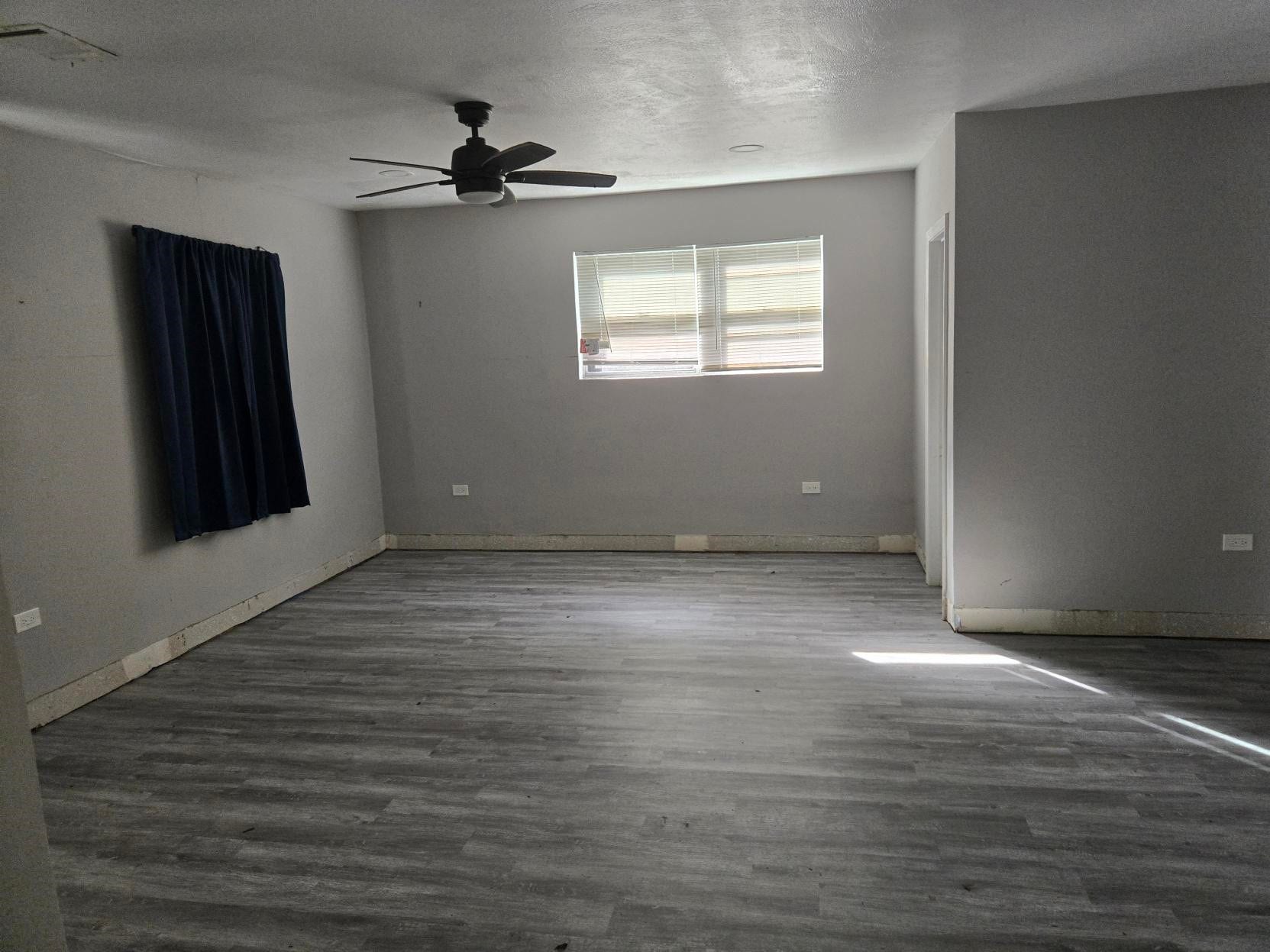 4611 Nevada, Dickinson, TX 77539 A room with a ceiling fan, a window, and light-colored flooring.