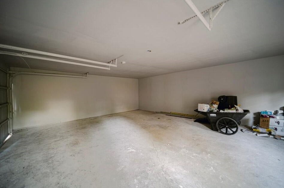 4611 Nevada, Dickinson, TX 77539 Spacious garage with concrete flooring, neutral walls, and overhead door.