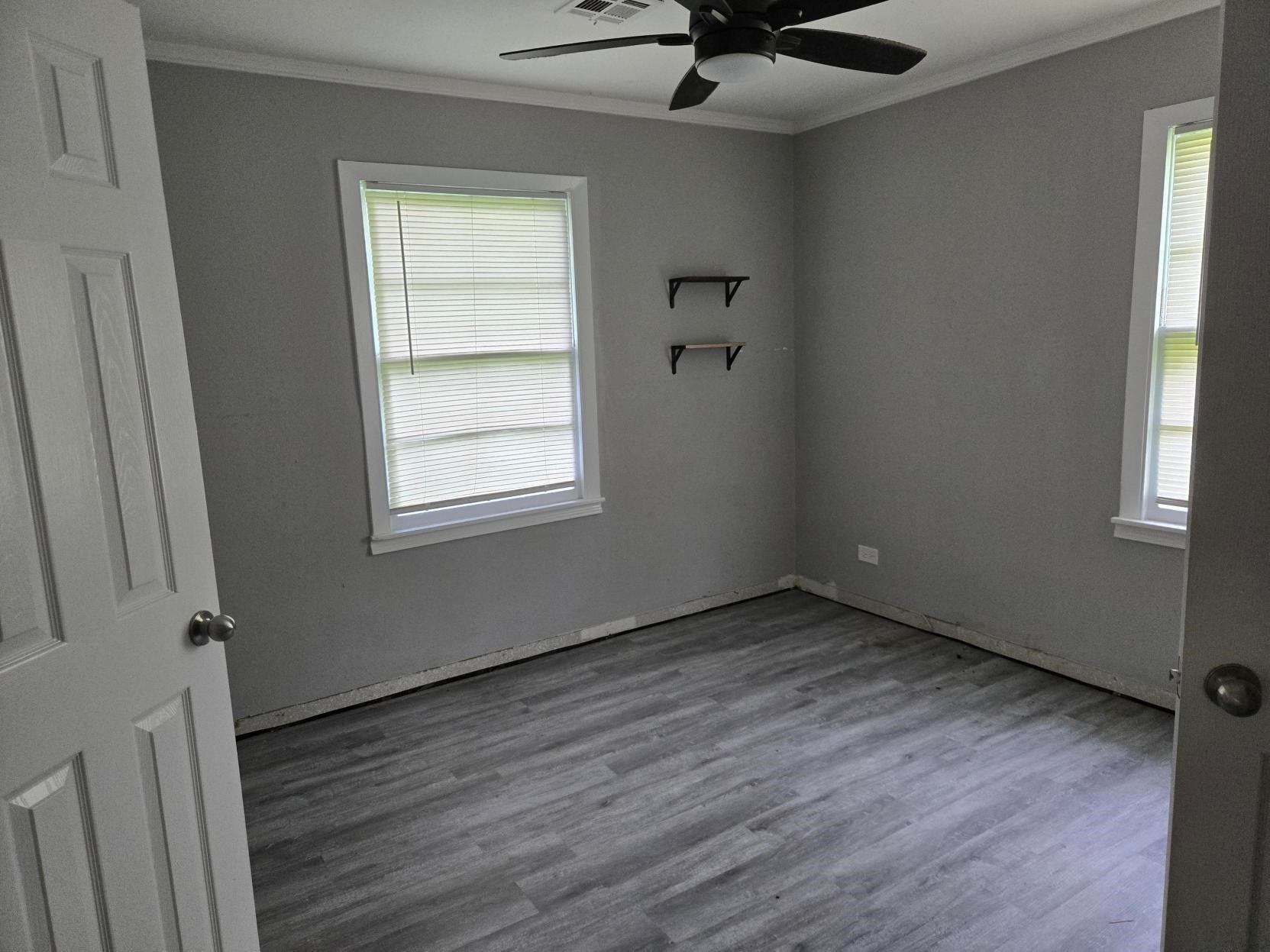 4611 Nevada, Dickinson, TX 77539 A simple, empty room with a ceiling fan, and wooden floors.