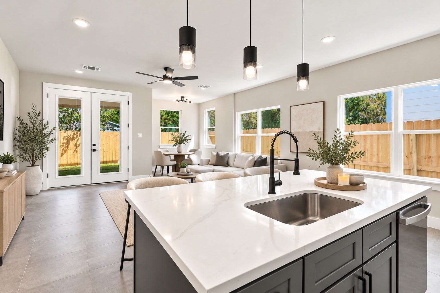 4313 Clover Street, #A/B, Houston, TX 77051 Bright and airy open-concept living area with a modern kitchen island, sleek fixtures, and large windows that let in abundant natural light.
*staging is AI generated*