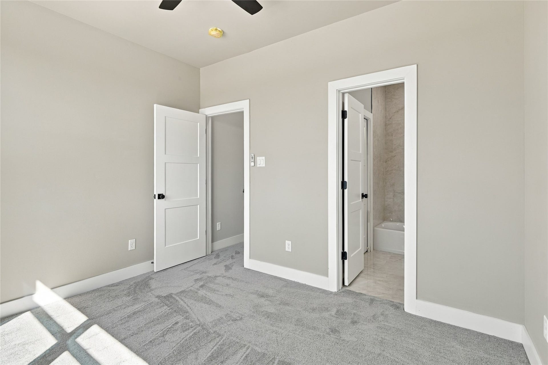 4313 Clover Street, #A/B, Houston, TX 77051 Bright and inviting bedroom with soft gray carpeting, fresh neutral walls, and convenient en-suite bathroom access.