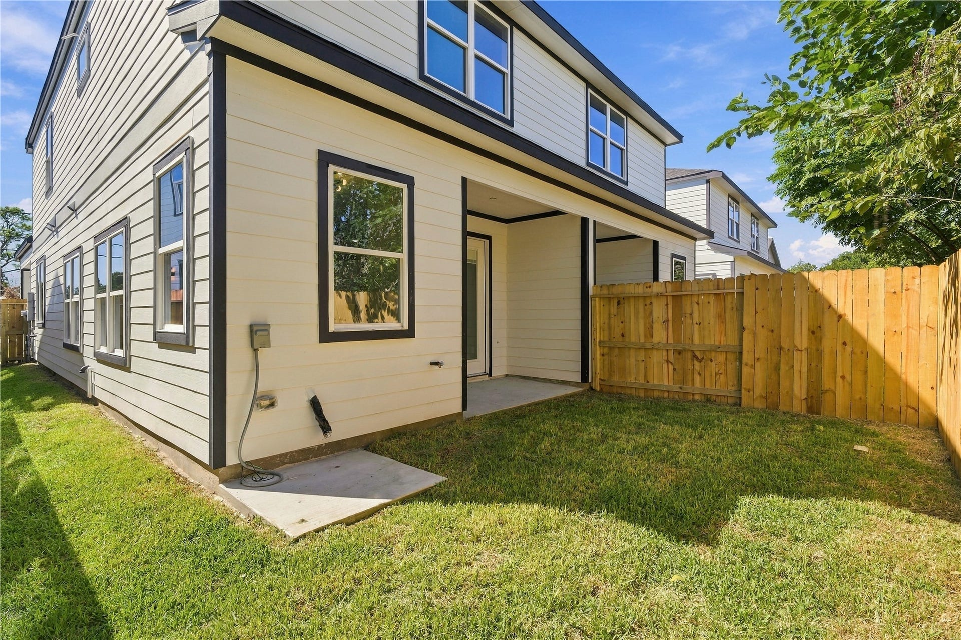 4313 Clover Street, #A/B, Houston, TX 77051 Charming backyard with a covered patio, perfect for outdoor relaxation, surrounded by a wooden fence for privacy.