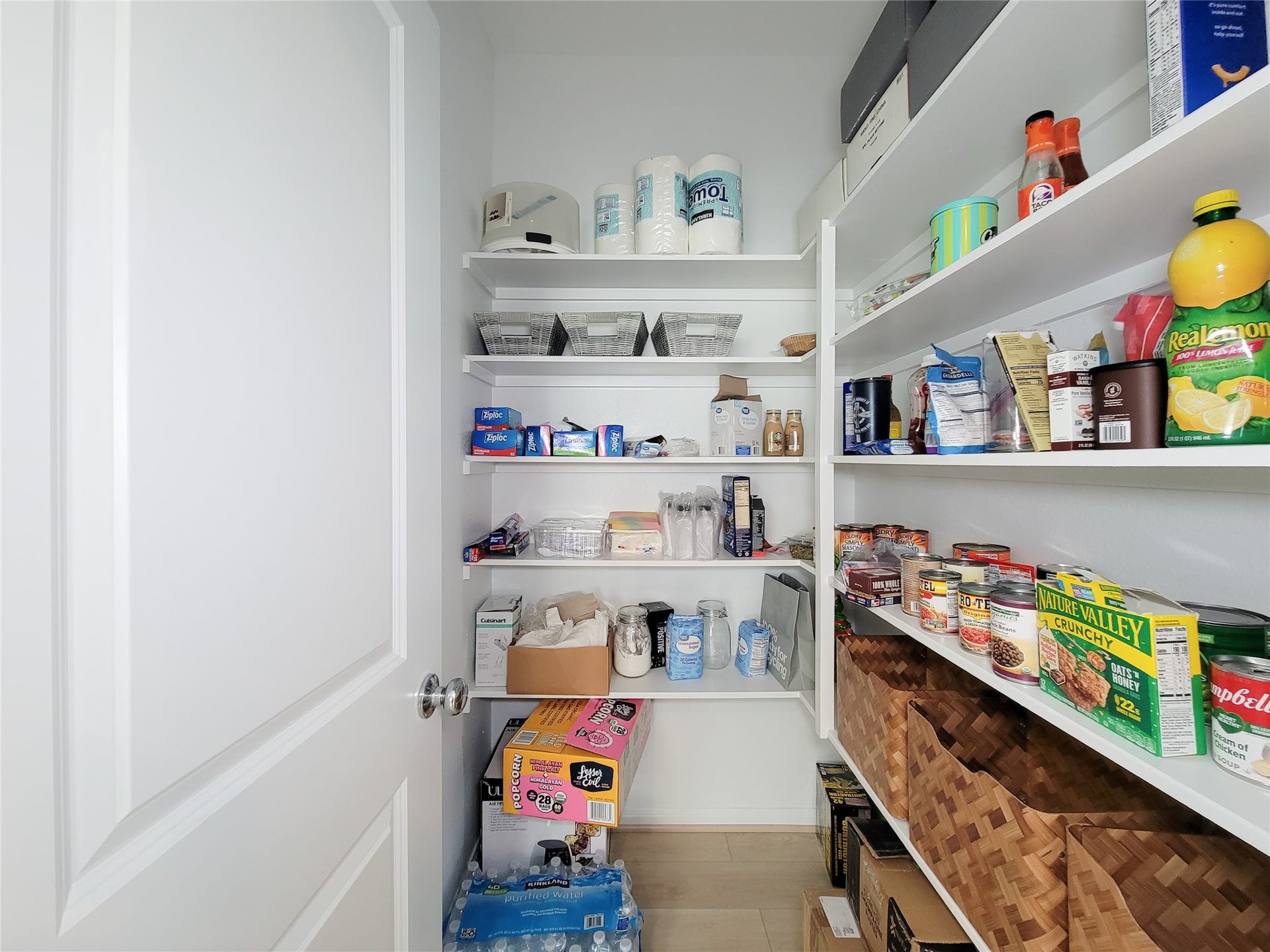 2719 Forest Retreat Lane, Missouri City, TX 77489 Pantry with white shelves. It features ample storage space, providing efficient organization for a busy household.