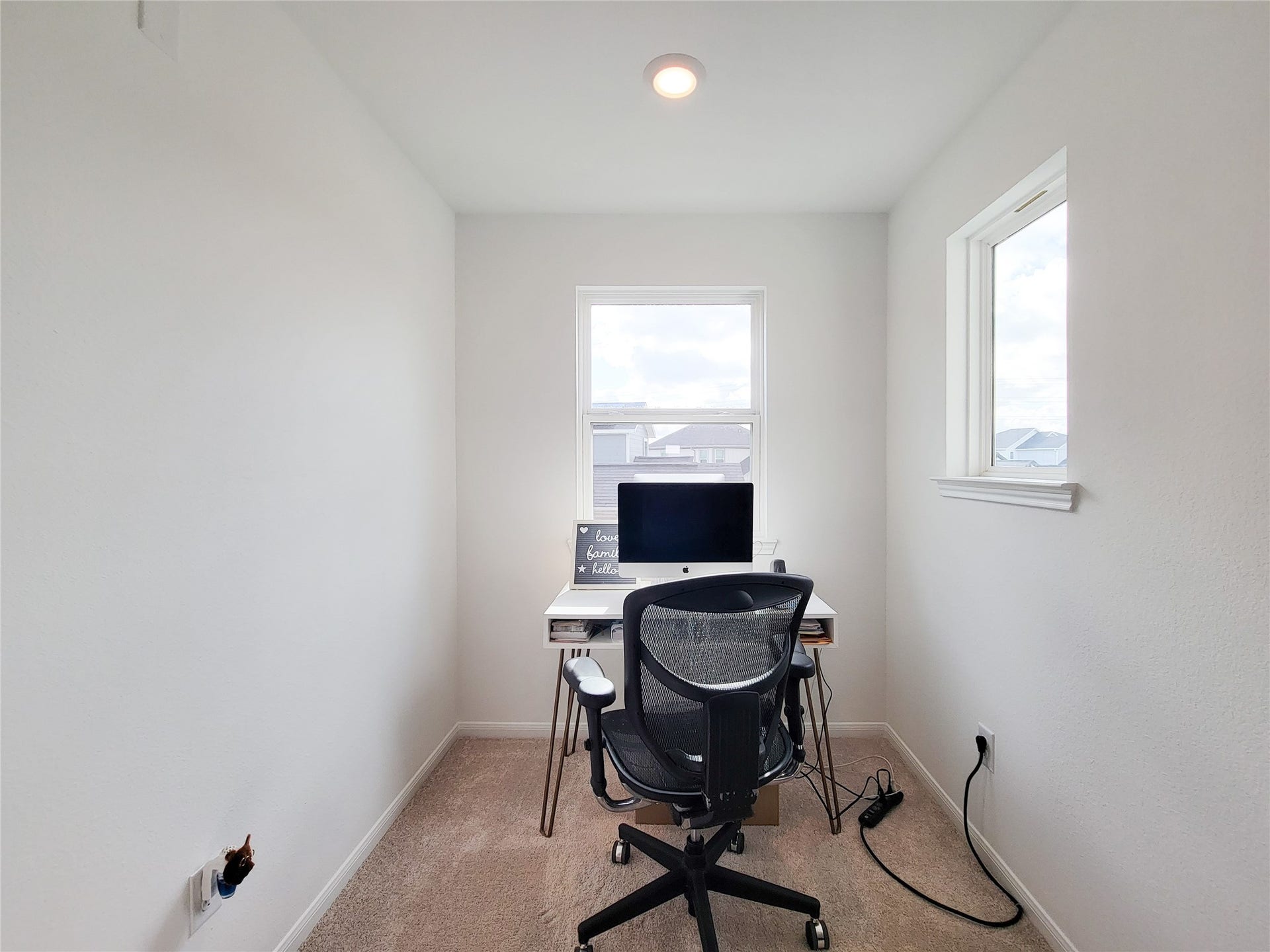 2719 Forest Retreat Lane, Missouri City, TX 77489 A compact, well-lit home office nook with a window view. It features neutral walls, carpet flooring, and space for a small desk and chair, ideal for focused work.