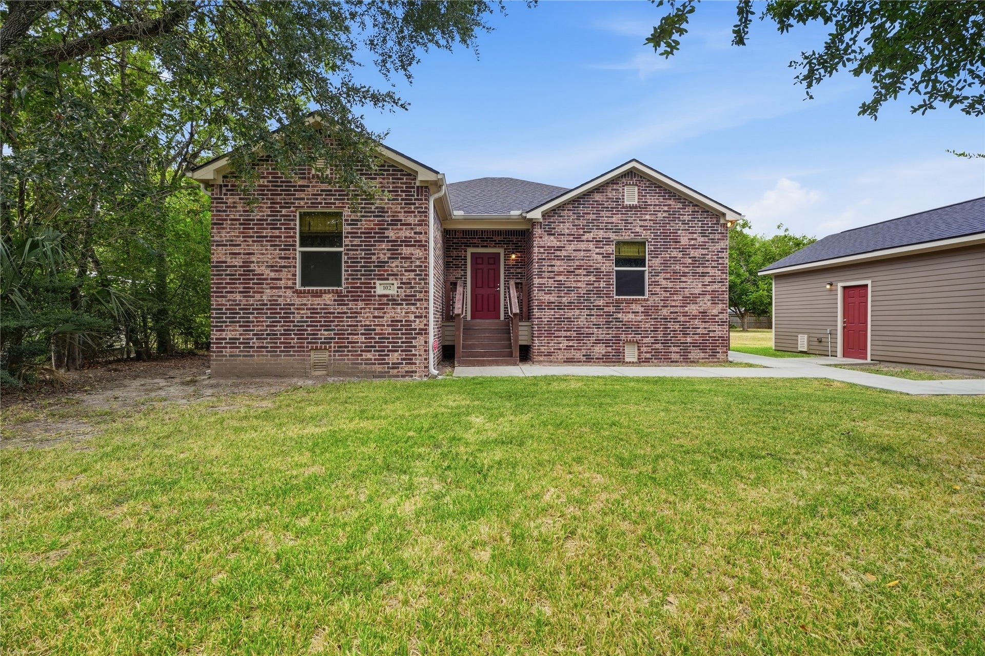 102 20th Avenue N, Texas City, TX 77590 Brick exterior with a covered front entry and mature trees that add shade to the front yard.