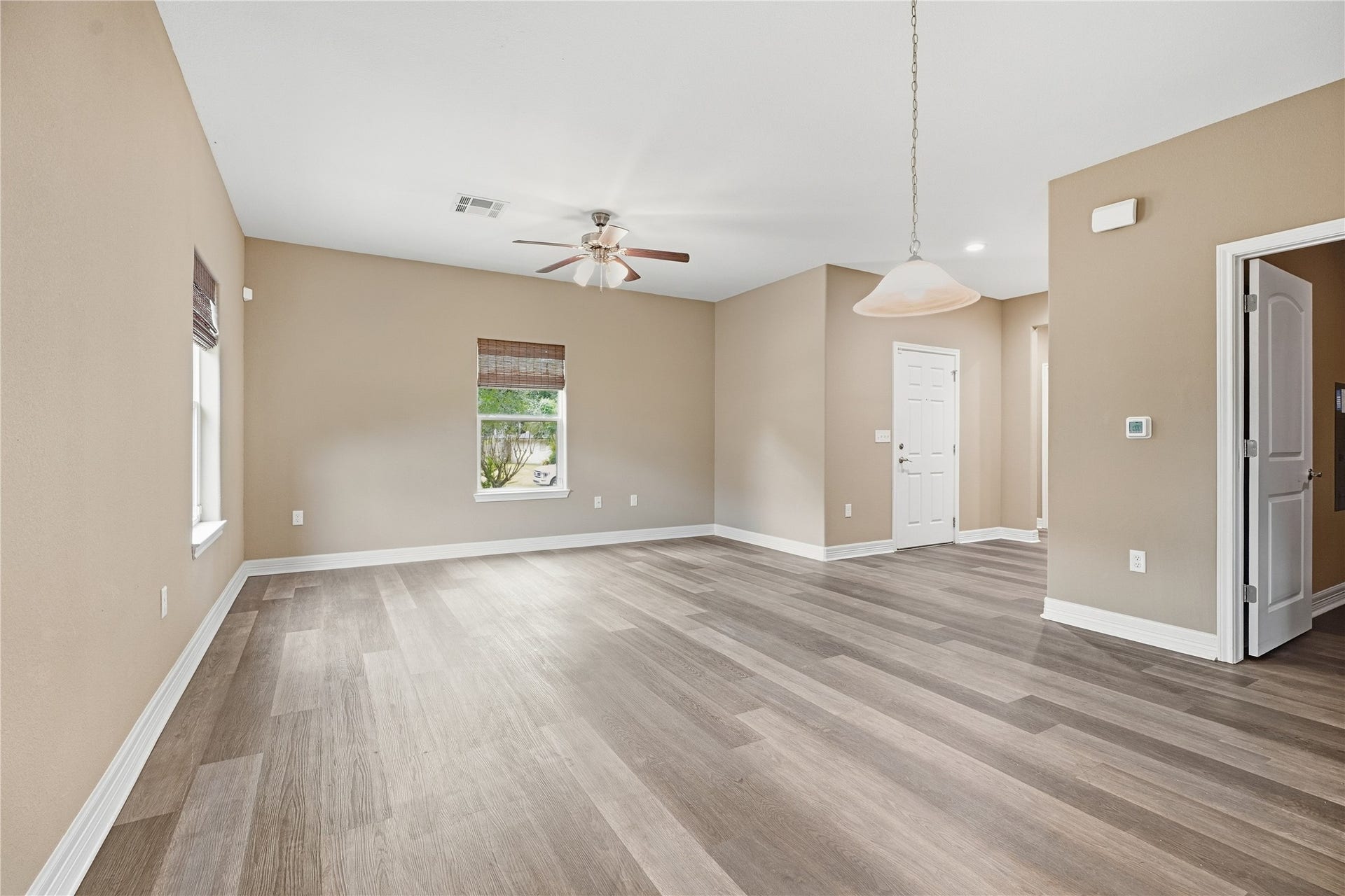 102 20th Avenue N, Texas City, TX 77590 Two windows bring natural light into the living room, which connects to the dining area for an open layout that keeps everyone together.