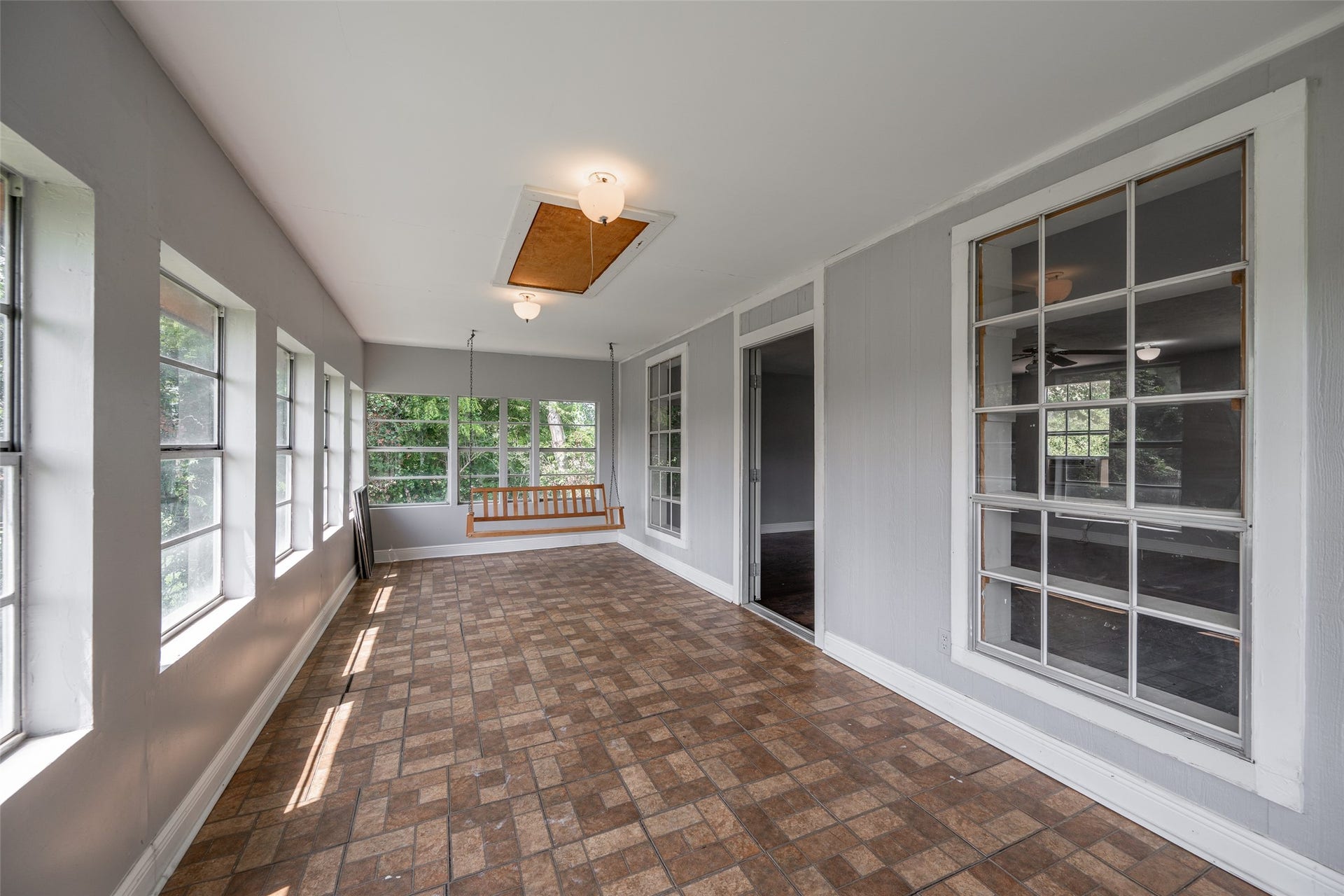 9311 Masters Road, Manvel, TX 77578 Experience abundant natural light in this inviting sunroom, featuring elegant flooring and a stylish chandelierperfect for relaxation or entertaining.