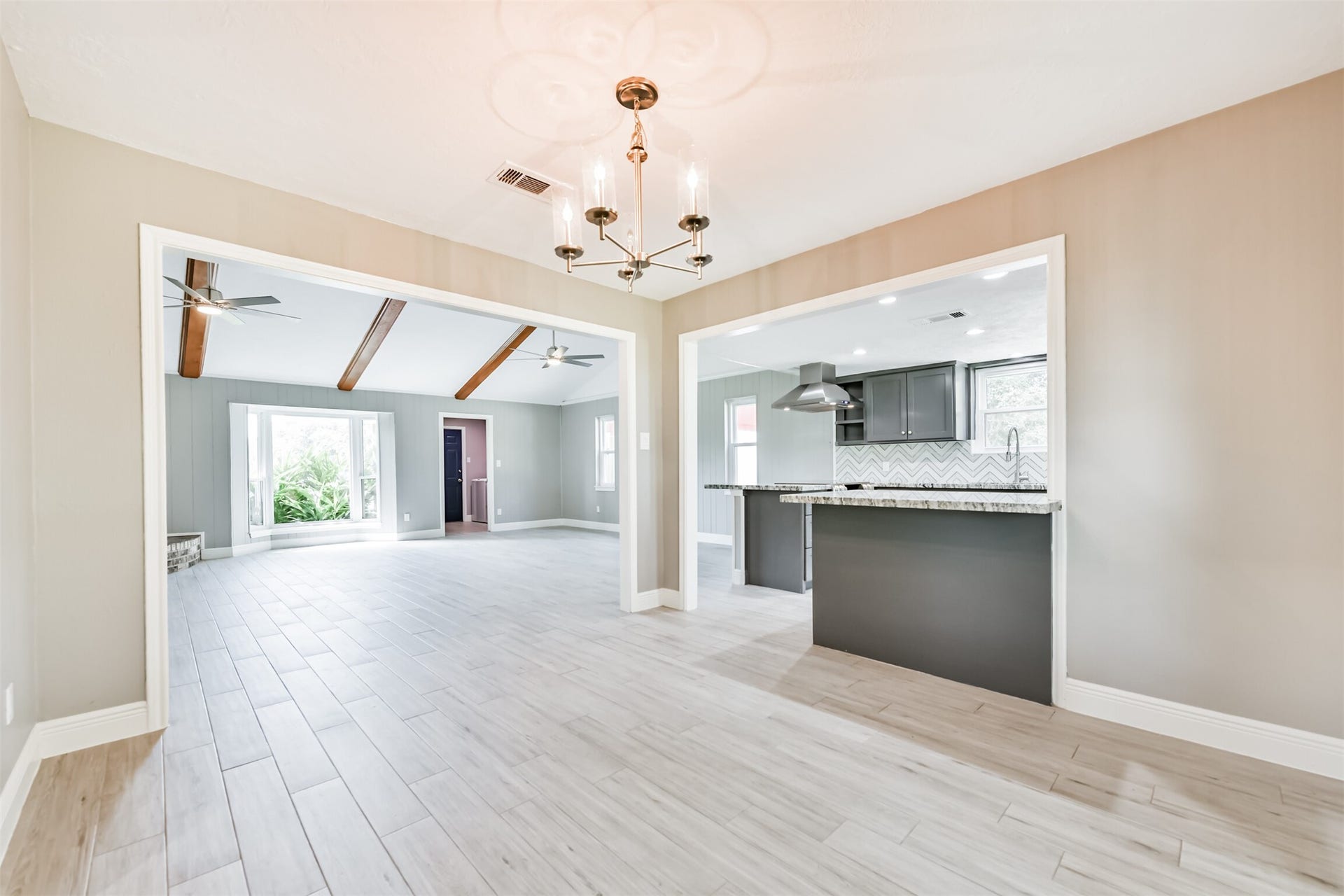 9311 Masters Road, Manvel, TX 77578 Enjoy your morning coffee in this inviting breakfast nook, featuring modern lighting and easy access to the kitchen and living area.