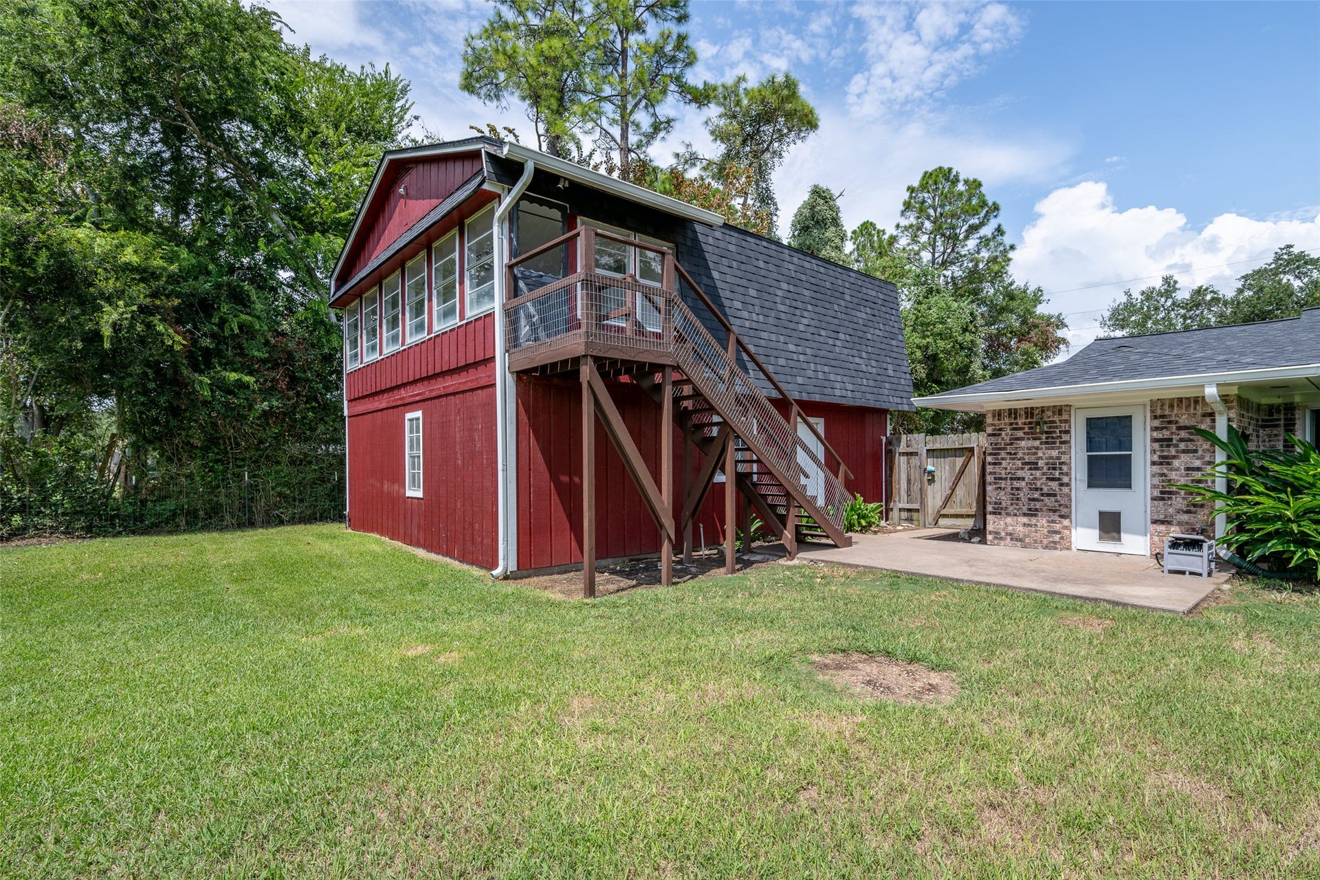 9311 Masters Road, Manvel, TX 77578 A view of the back of the home and bonus living quarters with a game room and sunroom