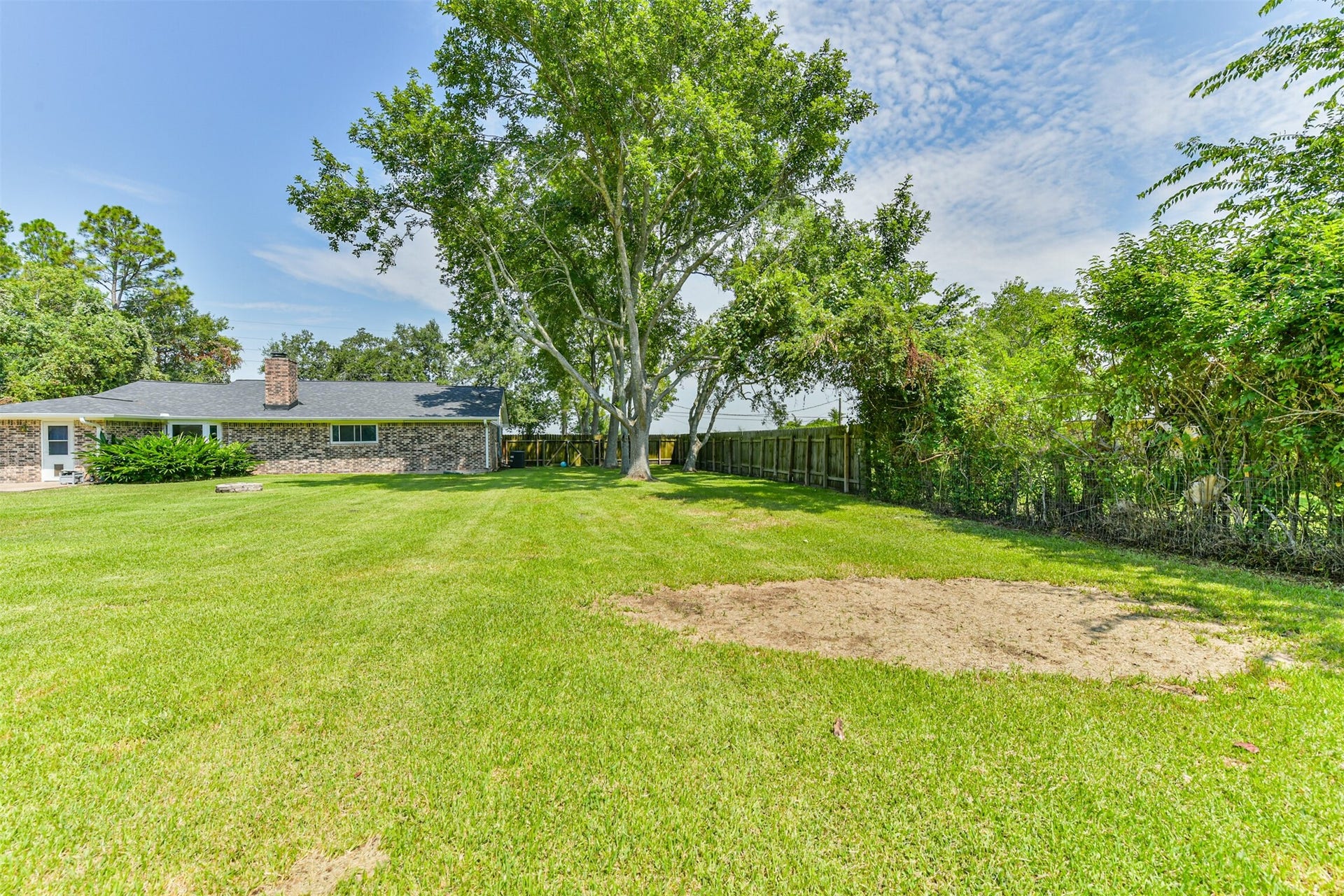 9311 Masters Road, Manvel, TX 77578 Expansive and serene, this backyard offers lush greenery, perfect for outdoor relaxation and entertainment. Ideal for family gatherings or peaceful retreats.