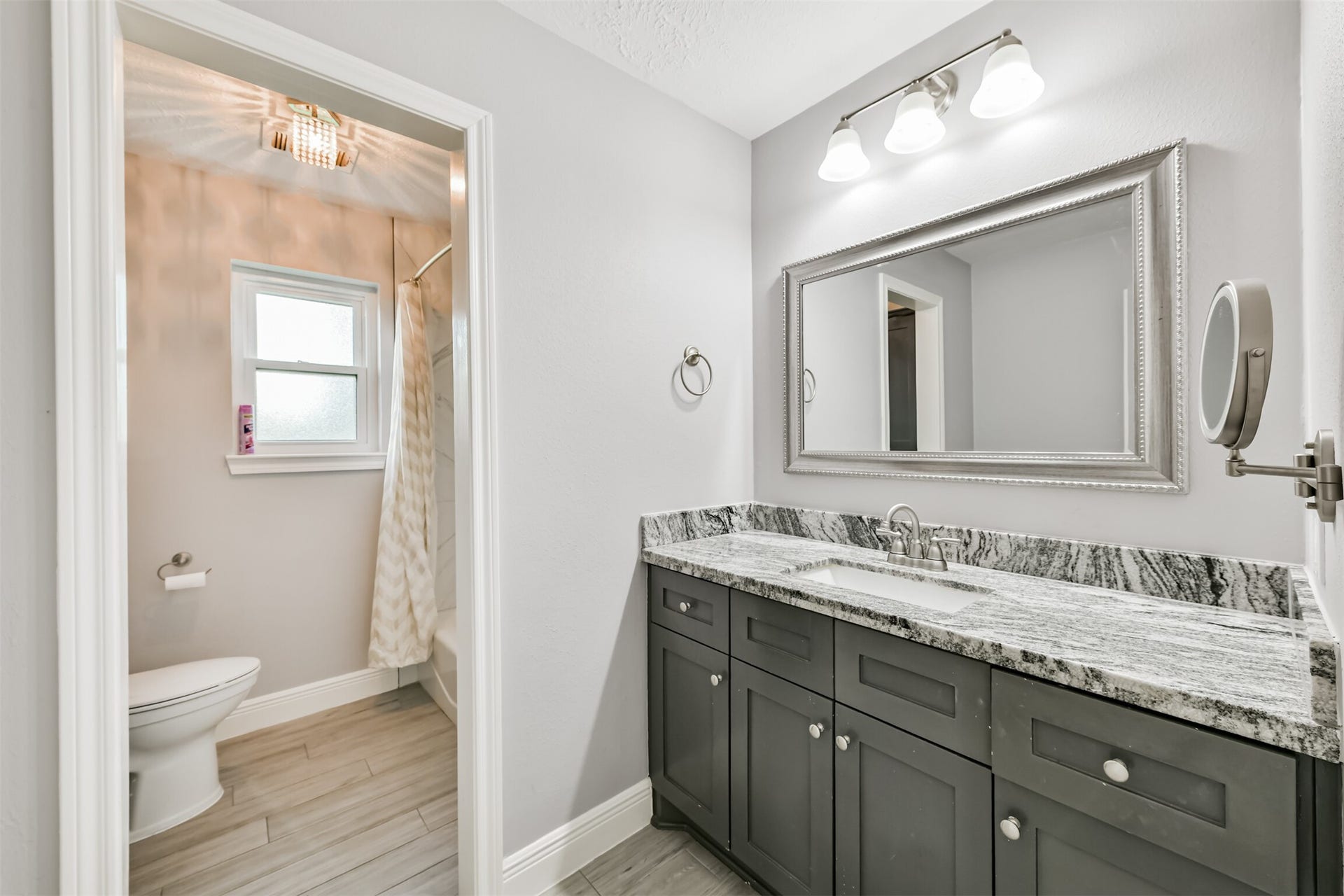 9311 Masters Road, Manvel, TX 77578 Luxurious full bath featuring a stylish dual-sink vanity, sleek granite countertops, and elegant fixtures, perfect for your relaxation and convenience.