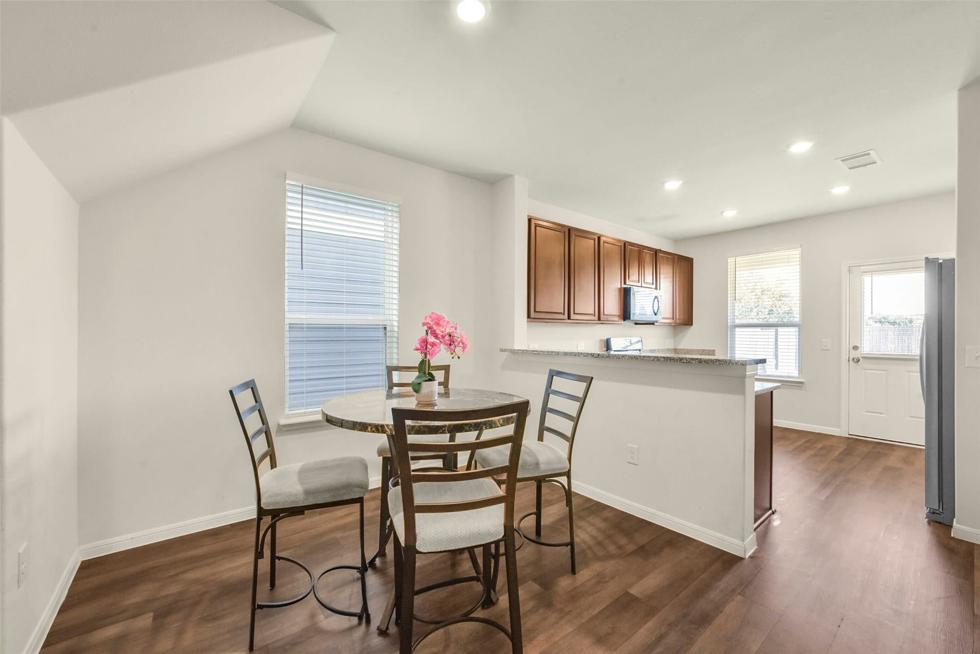 Dining area by the breakfast bar and kitchen.