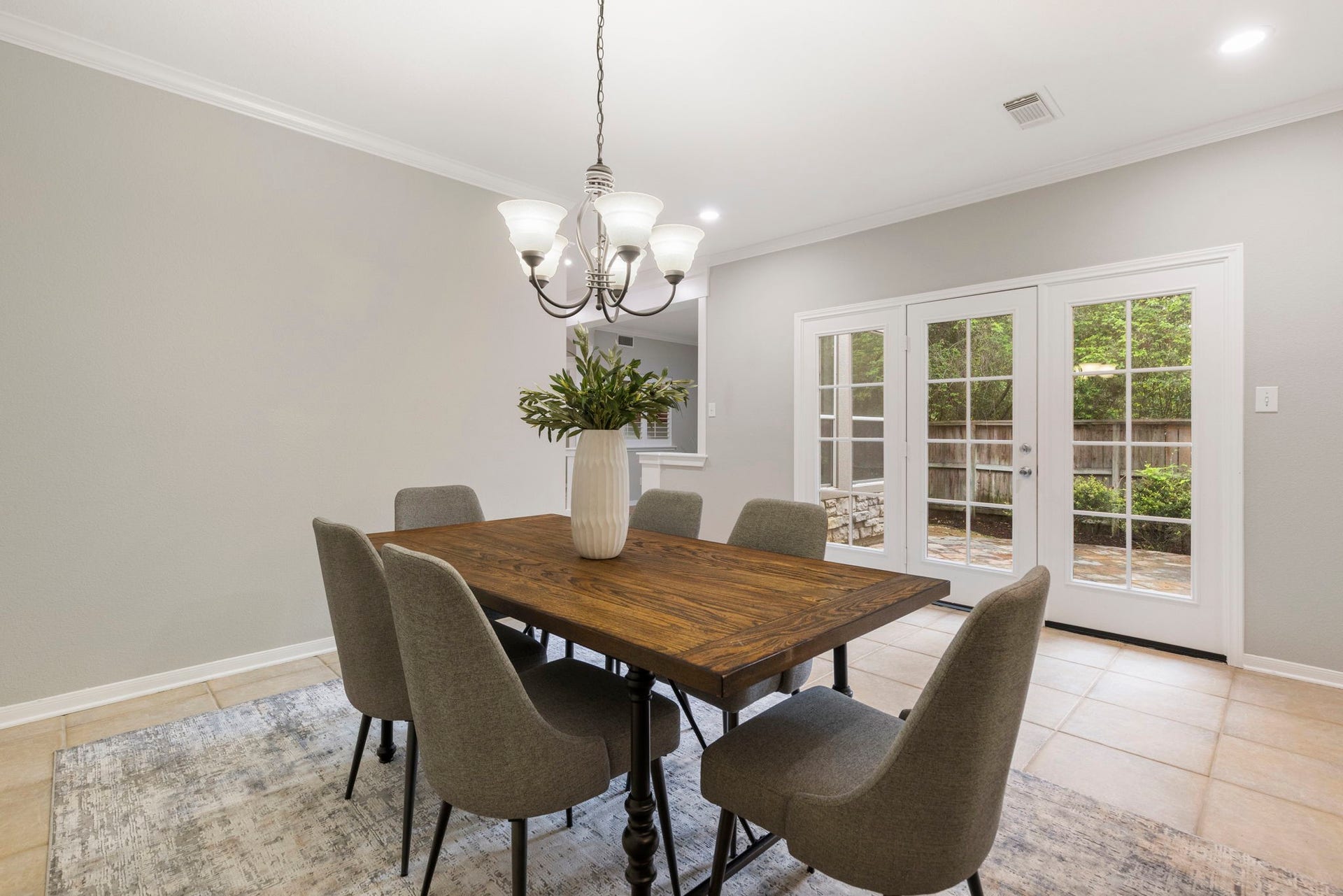 3 S Altwood Circle, The Woodlands, TX 77382 The dining room has double doors which lead onto the courtyard.