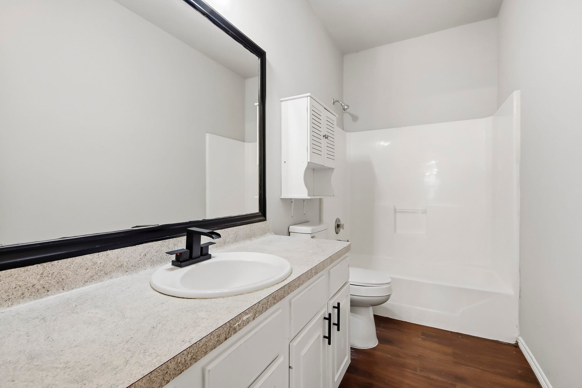 10023 Checkerberry Park Lane, Tomball, TX 77375 A bright and practical secondary bathroom that maximizes usability with its long vanity layout, smooth countertops, and spacious tub-shower setup.
