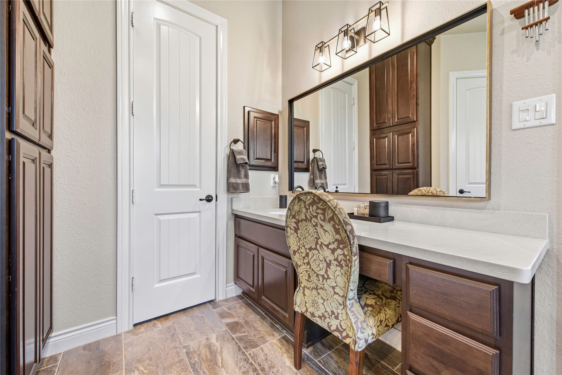 Spacious bathroom featuring a double vanity, custom cabinetry and generous counter space.