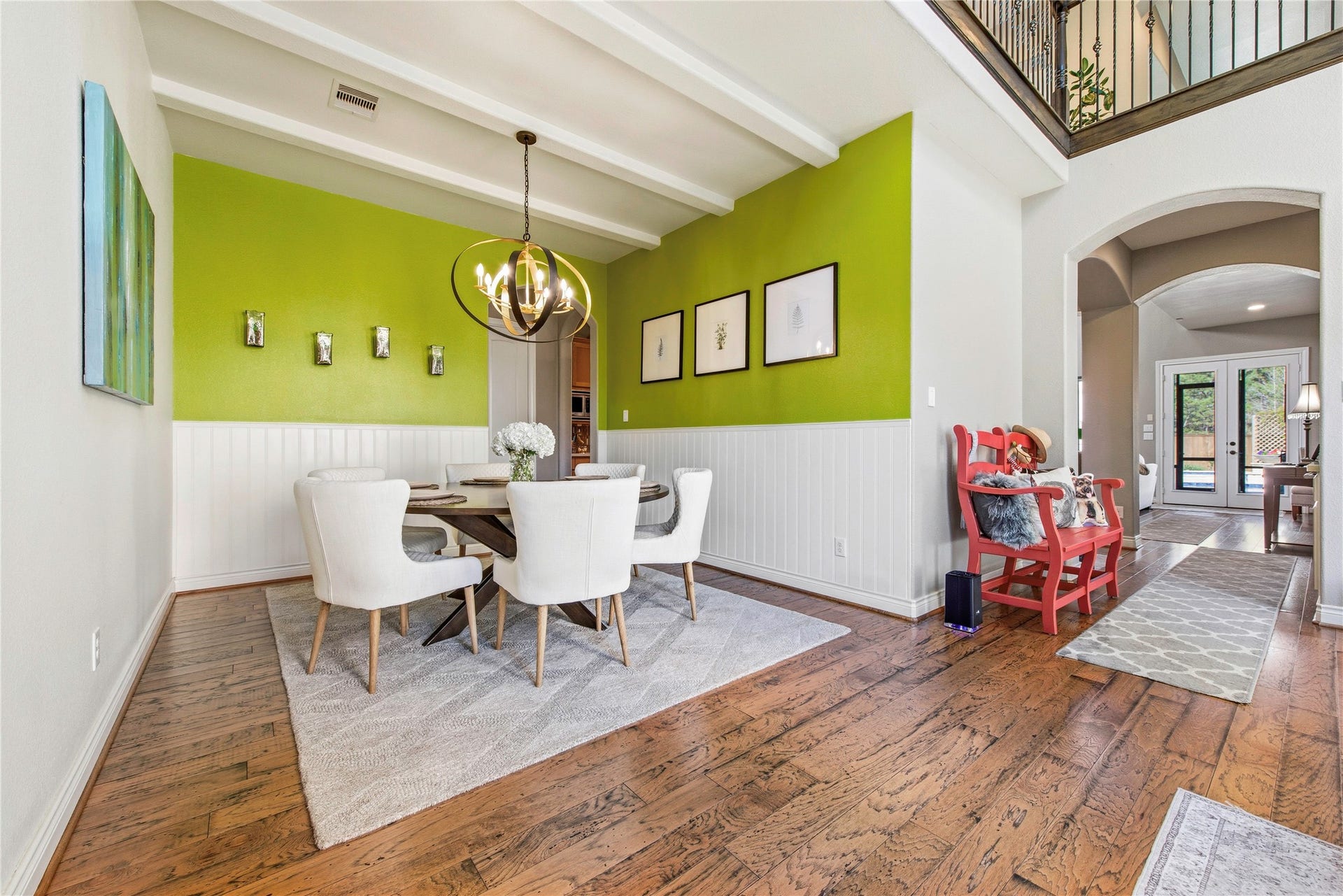 Dining area featuring a stylish chandelier, wainscoting and spacious seating area.