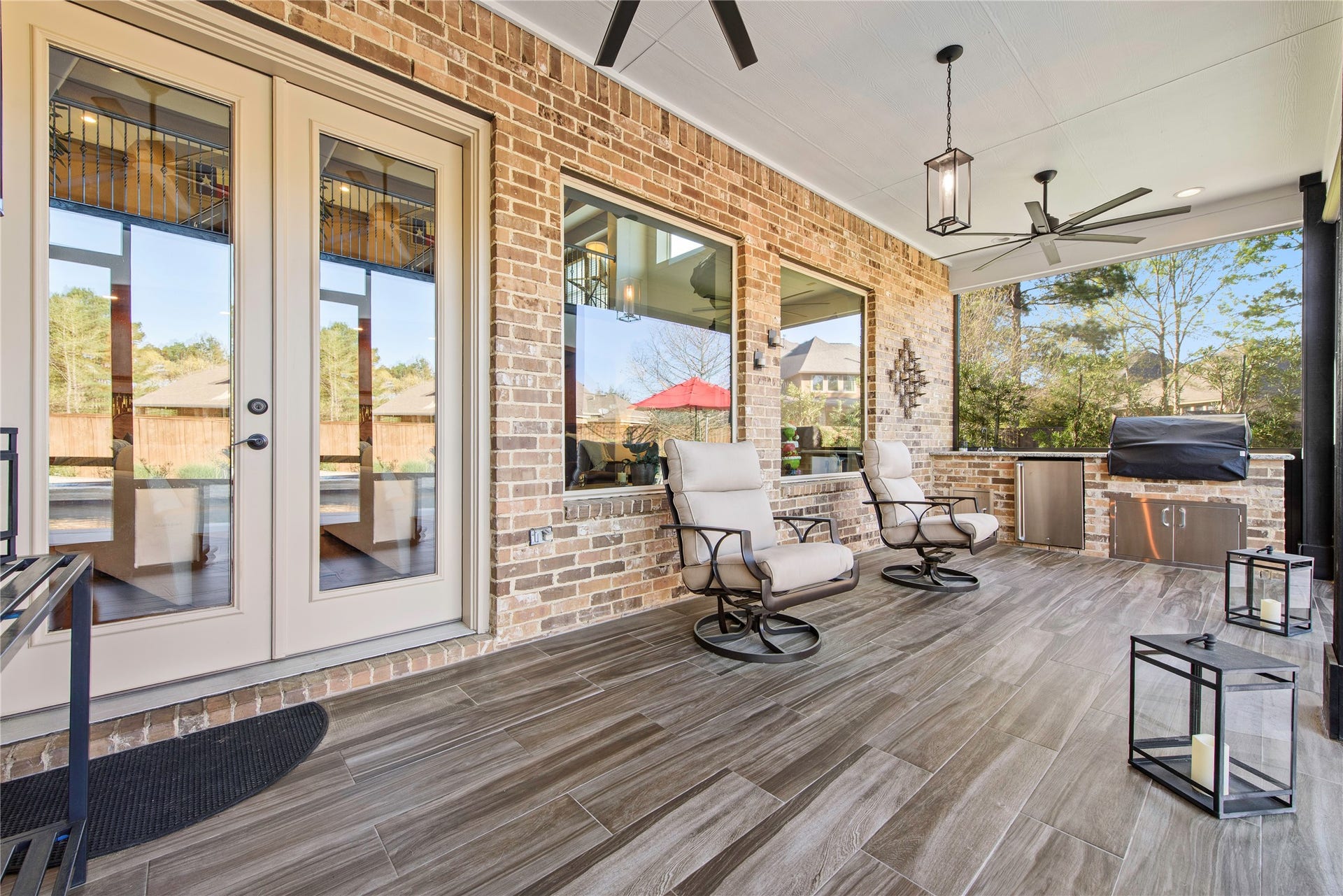 Spacious covered patio featuring outdoor seating and expansive views of the pool and backyard.