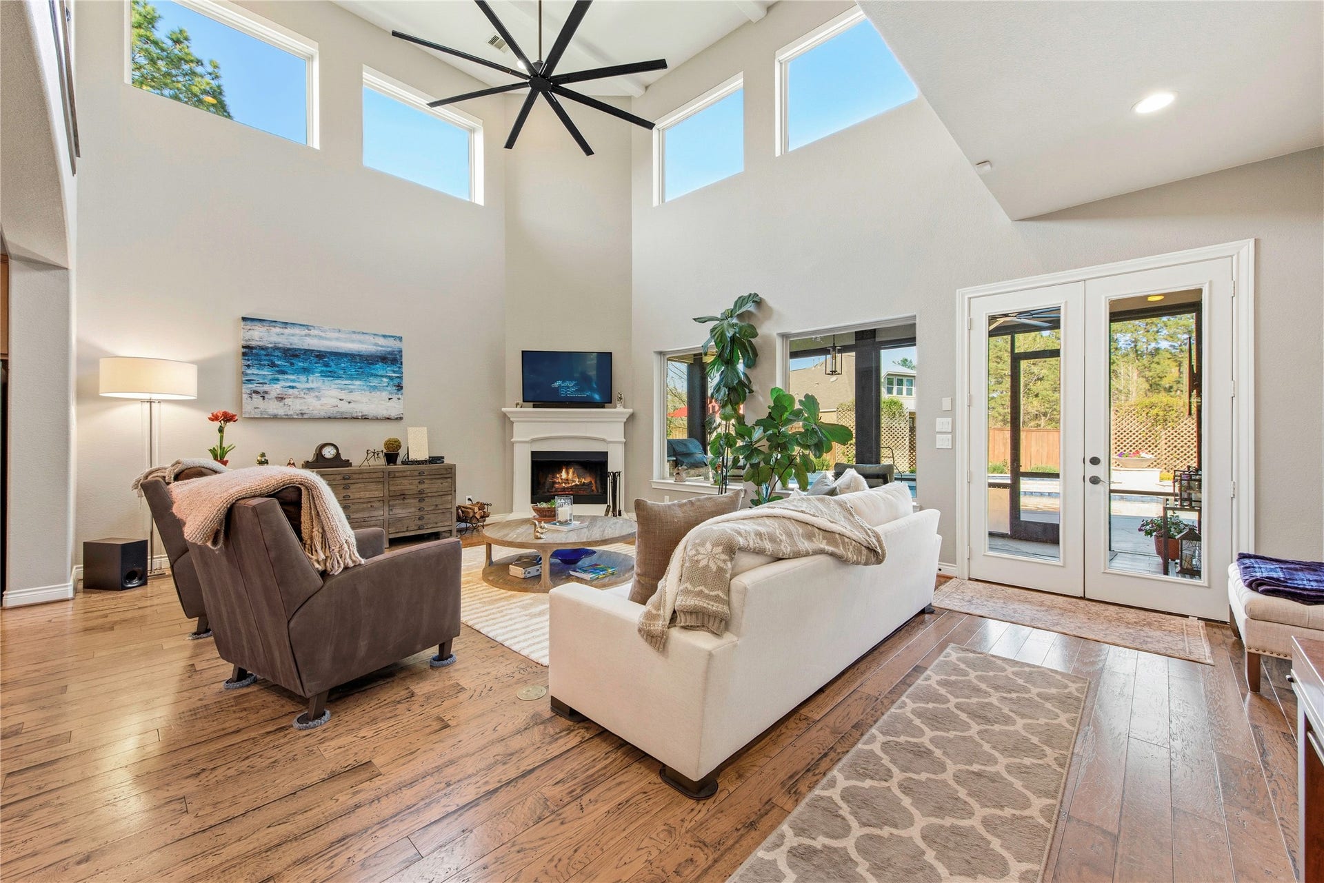 Spacious living room showcasing soaring ceilings, architectural details and abundant natural light.