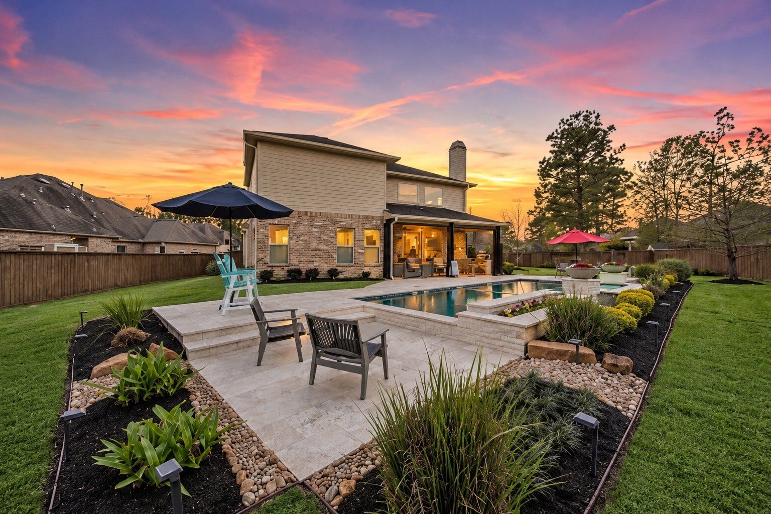 Sparkling backyard pool with expansive patio and peaceful wooded views.