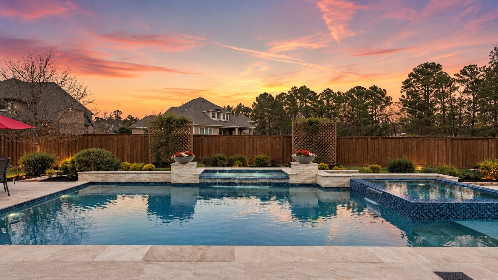 Sparkling backyard pool with expansive patio and peaceful wooded views.