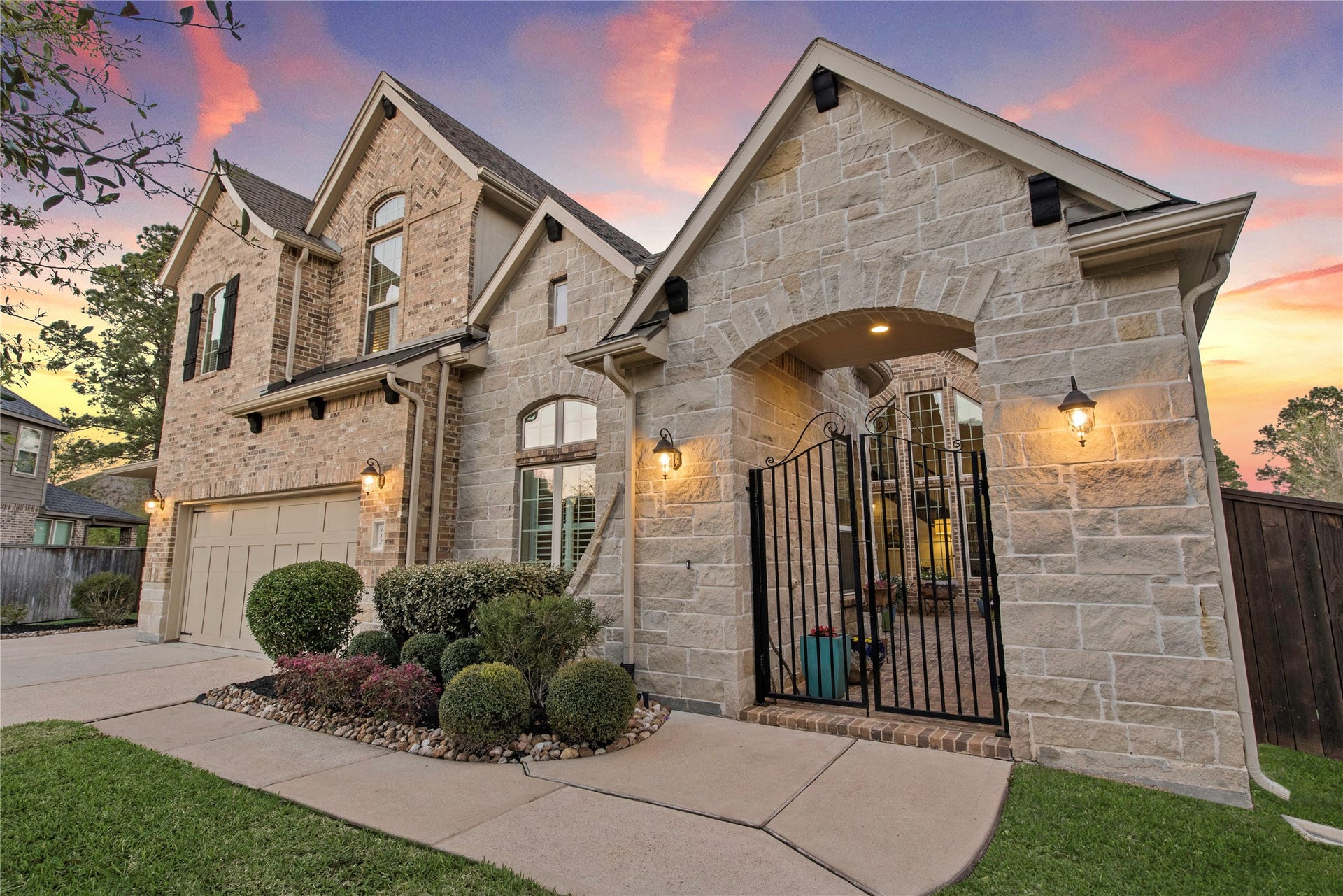 Inviting front elevation with manicured landscaping and covered entry.