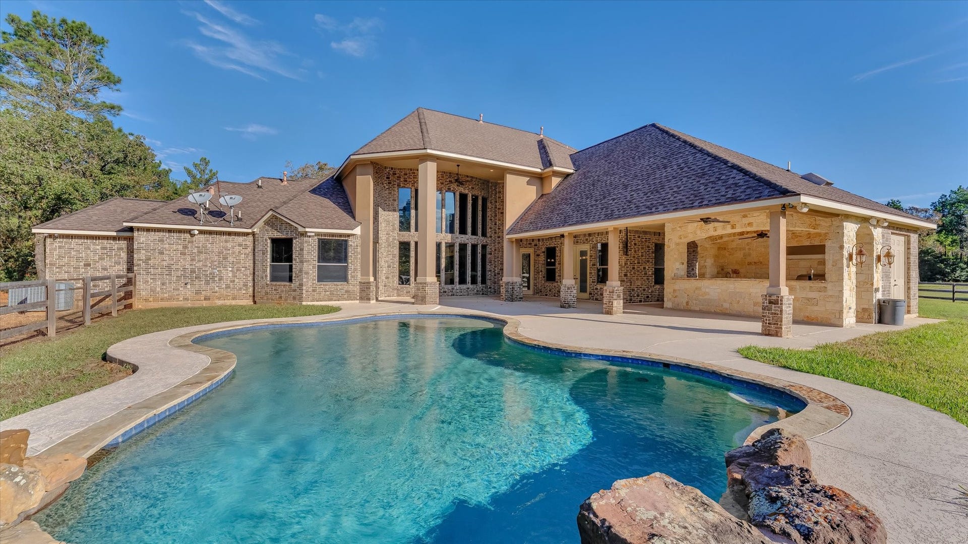 8071 Stacy Diane Drive, Montgomery, TX 77316 This stunning home features a spacious backyard with a beautiful swimming pool, complemented by a large covered patio and elegant brick exterior. Perfect for outdoor entertainment and relaxation.