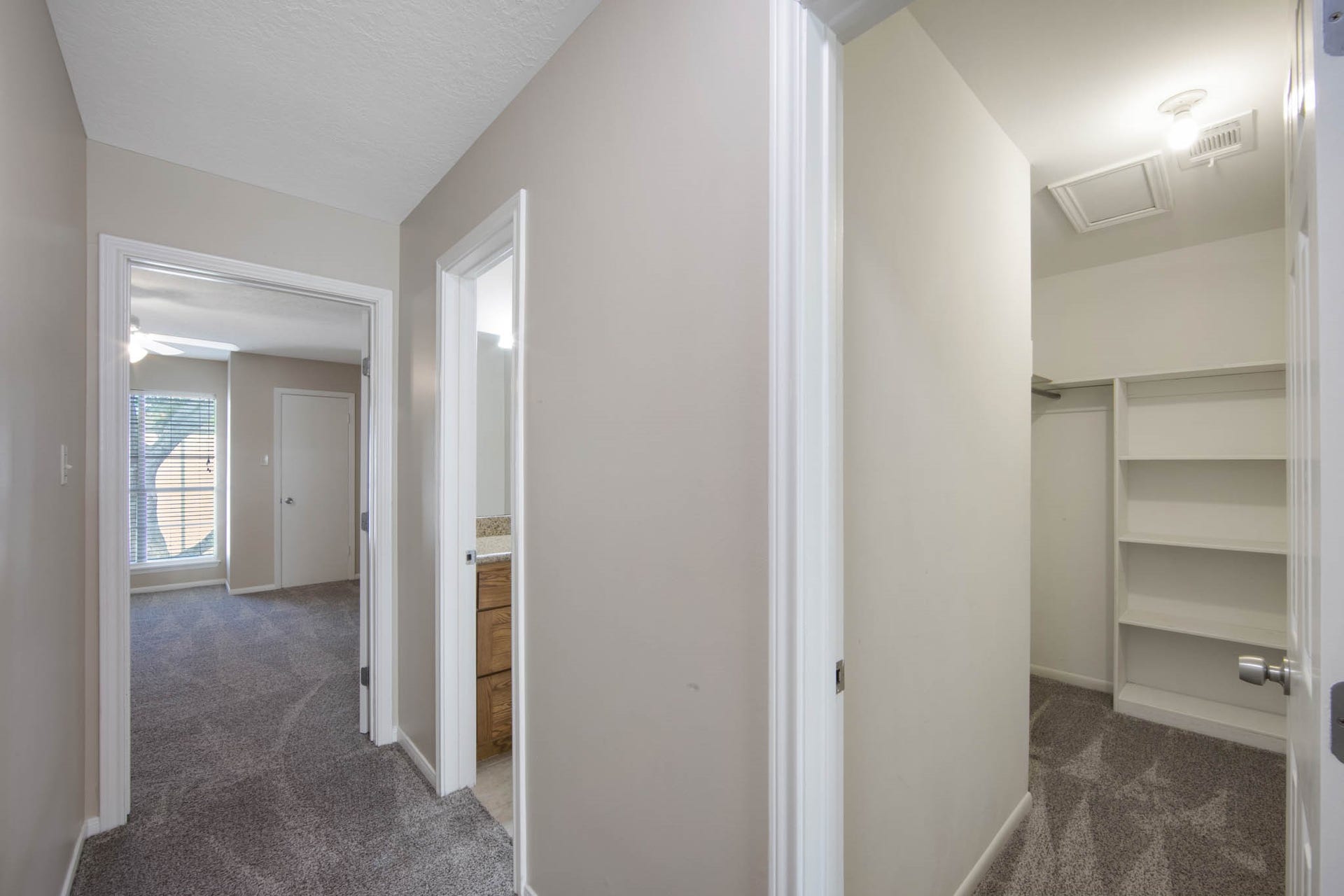 Hallway leading to 4th bedroom and a view of the storage closet upstairs