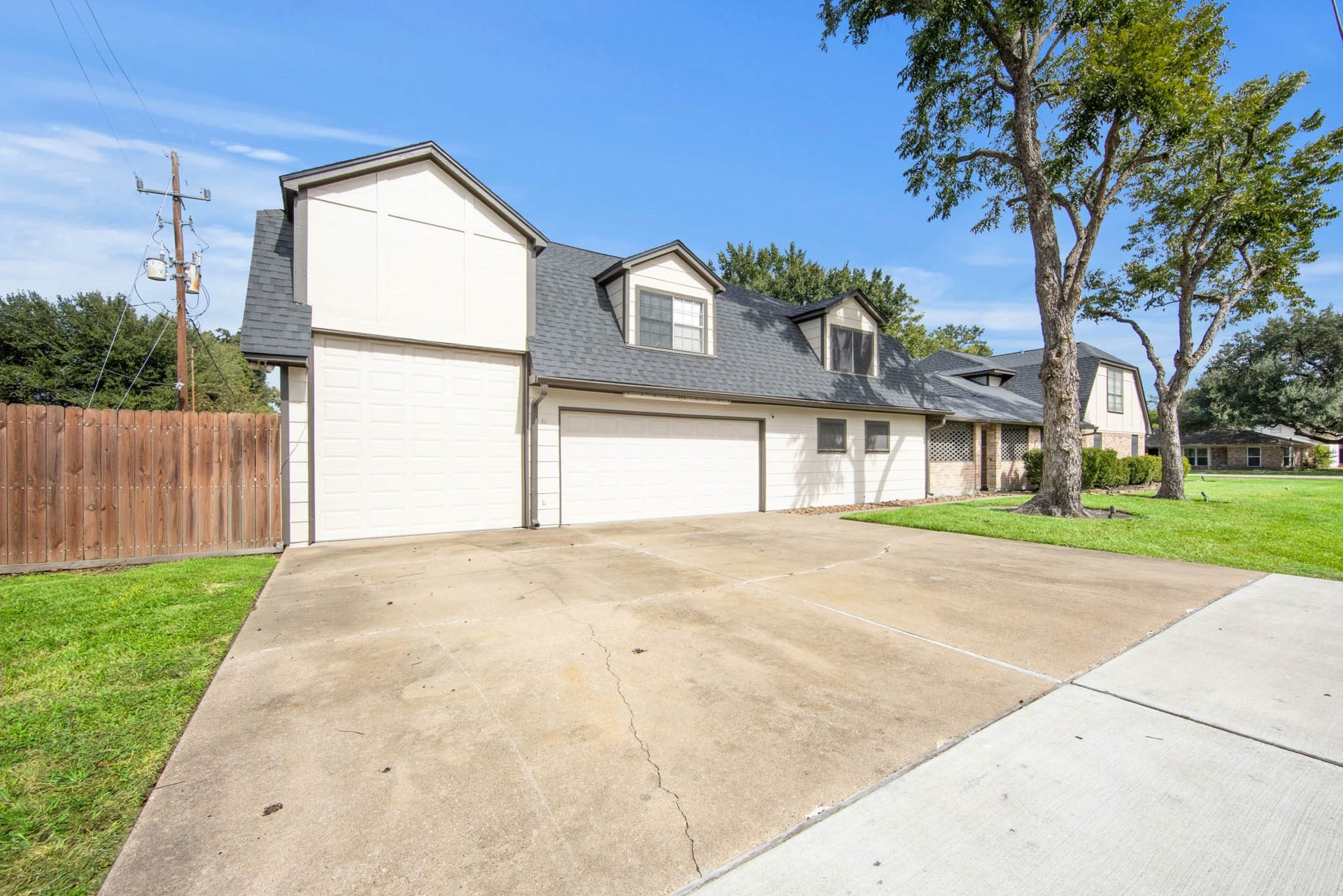 Oversized Concrete driveway that can easily fit 6 cars.  The tall garage space has a roll up door