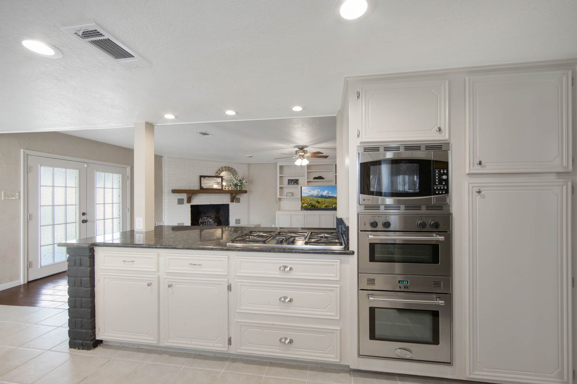 The kitchen has dual ovens, a gas stove, pull out drawers for storage, and a large pantry